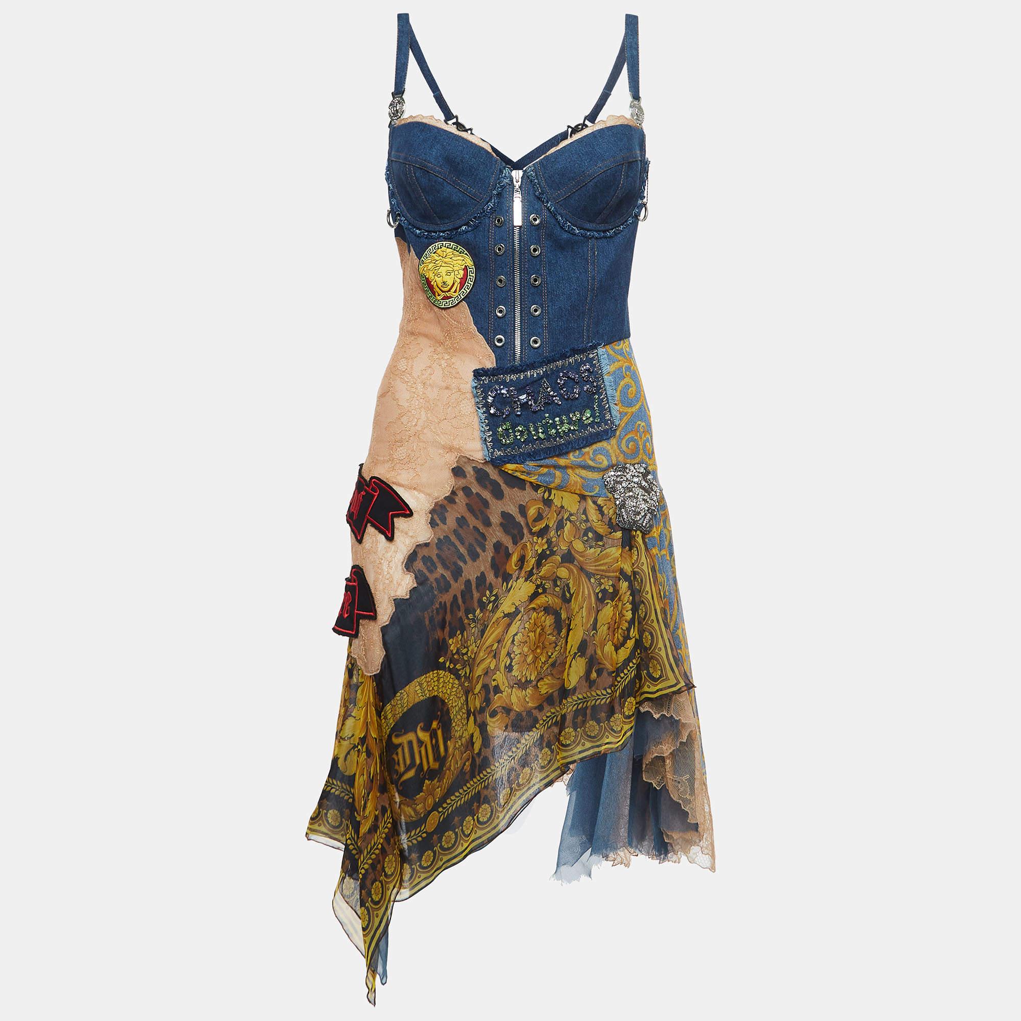 This stunning Versace vintage corset dress is a timeless fusion of elegance and edginess. Crafted with intricate applique detailing, the denim and nylon fabric blend seamlessly, while the asymmetric silhouette adds a modern flair.

Includes: brand
