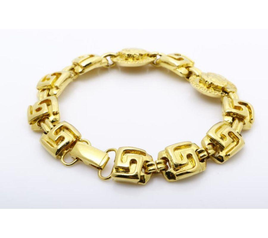 Versace Vintage Bracelet features chunky gold-tone hardware, bold Medusa medallions and a latch closure.
 

58007MSC
