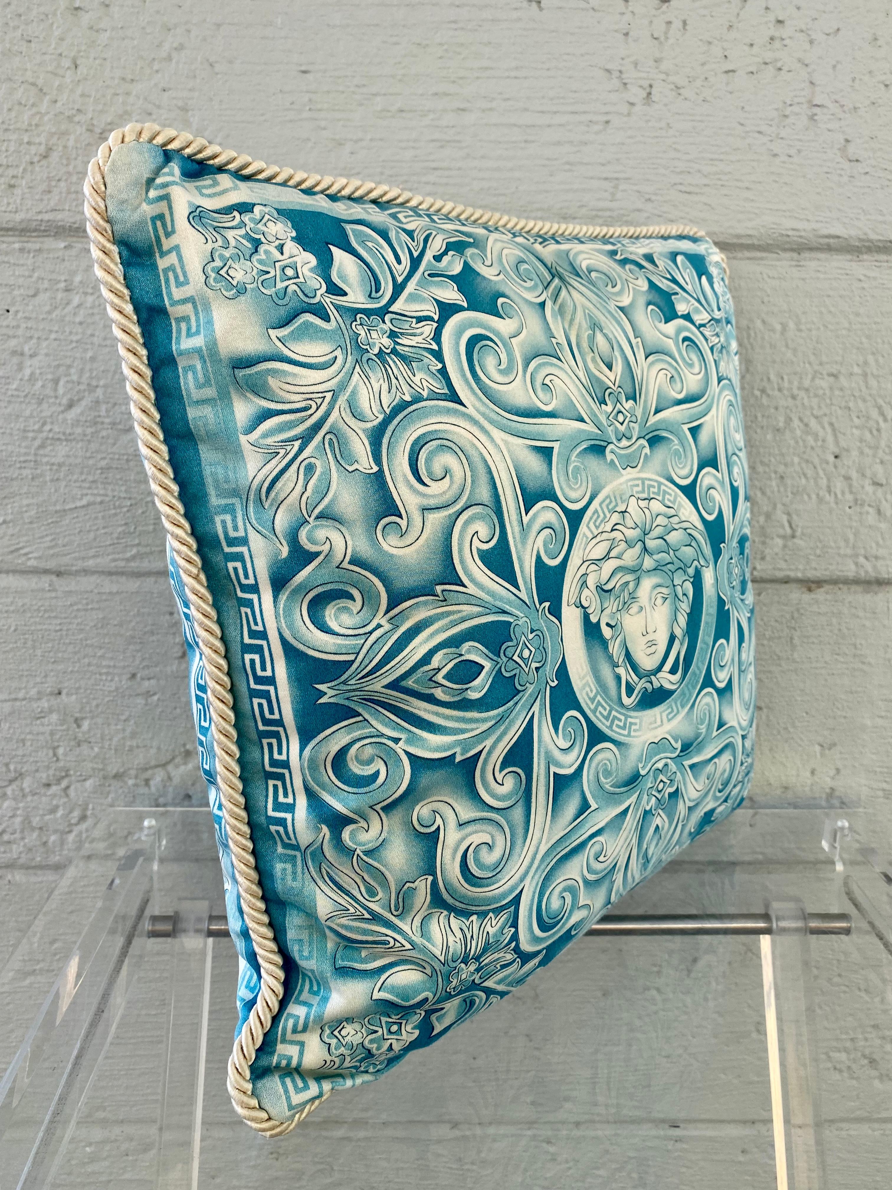Iconic and timeless circa 1990's creation by Versace. Add high fashion to any space with this Medusa pillow. Crafted from 100% cotton and is embellished with the iconic Versace motif. With its stunning color, the pillow adds the finishing touch to
