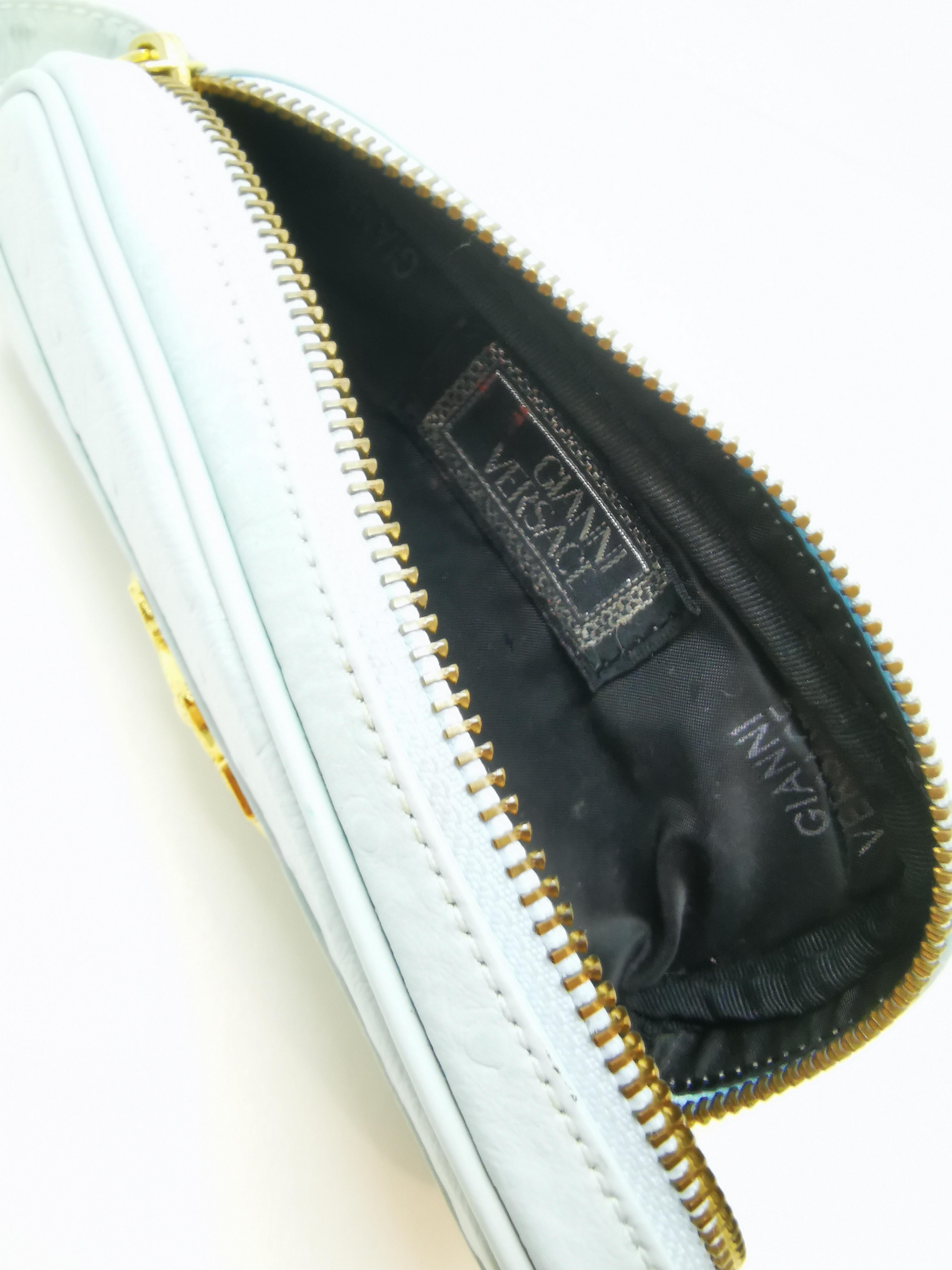 Step into the glamour of the 1990s with this Gianni Versace blue ostrich-patterned leather pouch. Crafted during one of the most iconic eras of fashion, this pouch encapsulates the bold and luxurious style Versace is known for. The leather, embossed