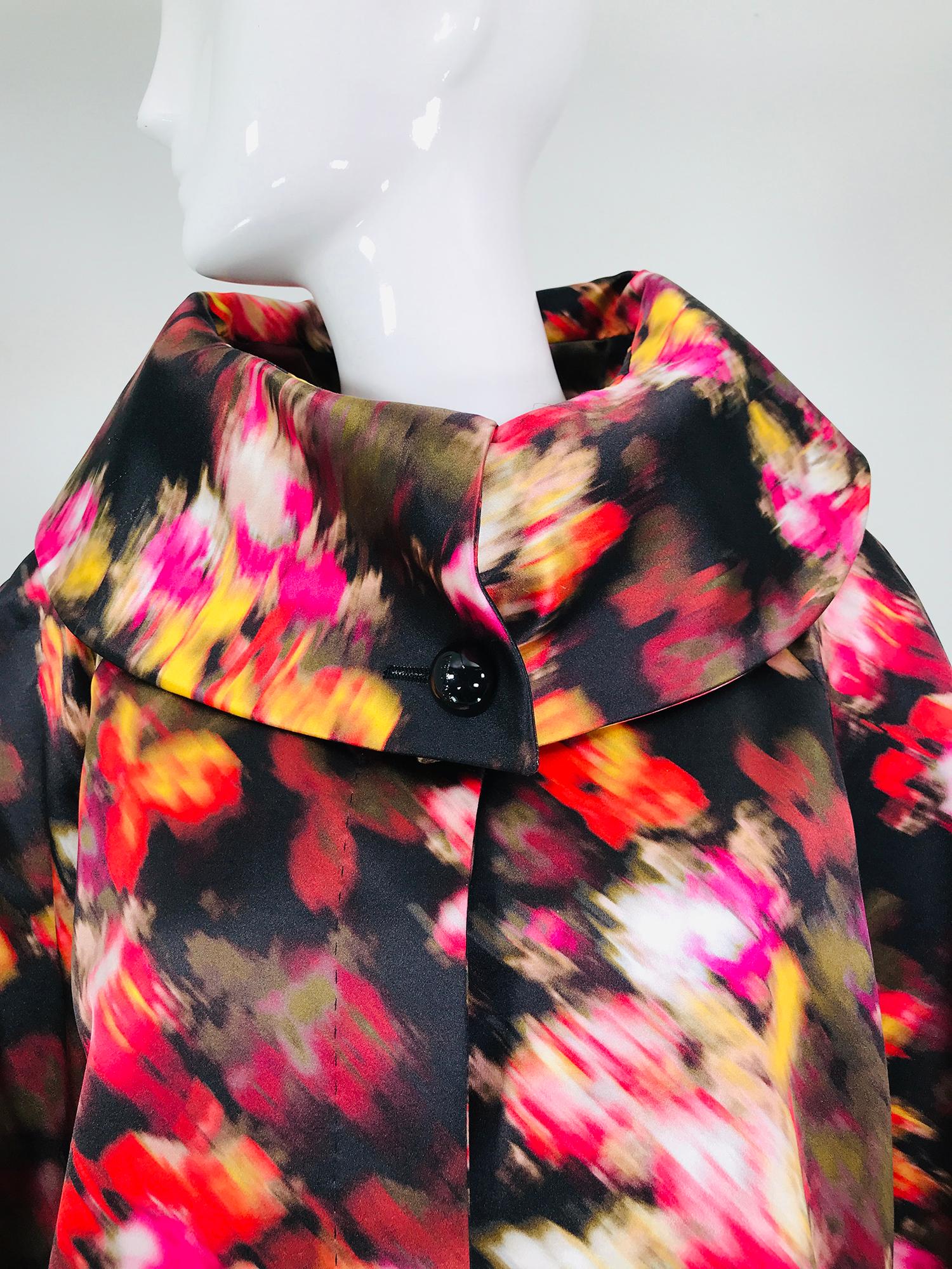 Versace watery floral silk coat with a rolled stand away collar, new with tags. A beautiful coat with a gorgeous print. Raglan sleeves, the collar is wide and when the coat is fastened it stands away from the neck. A single large button at the