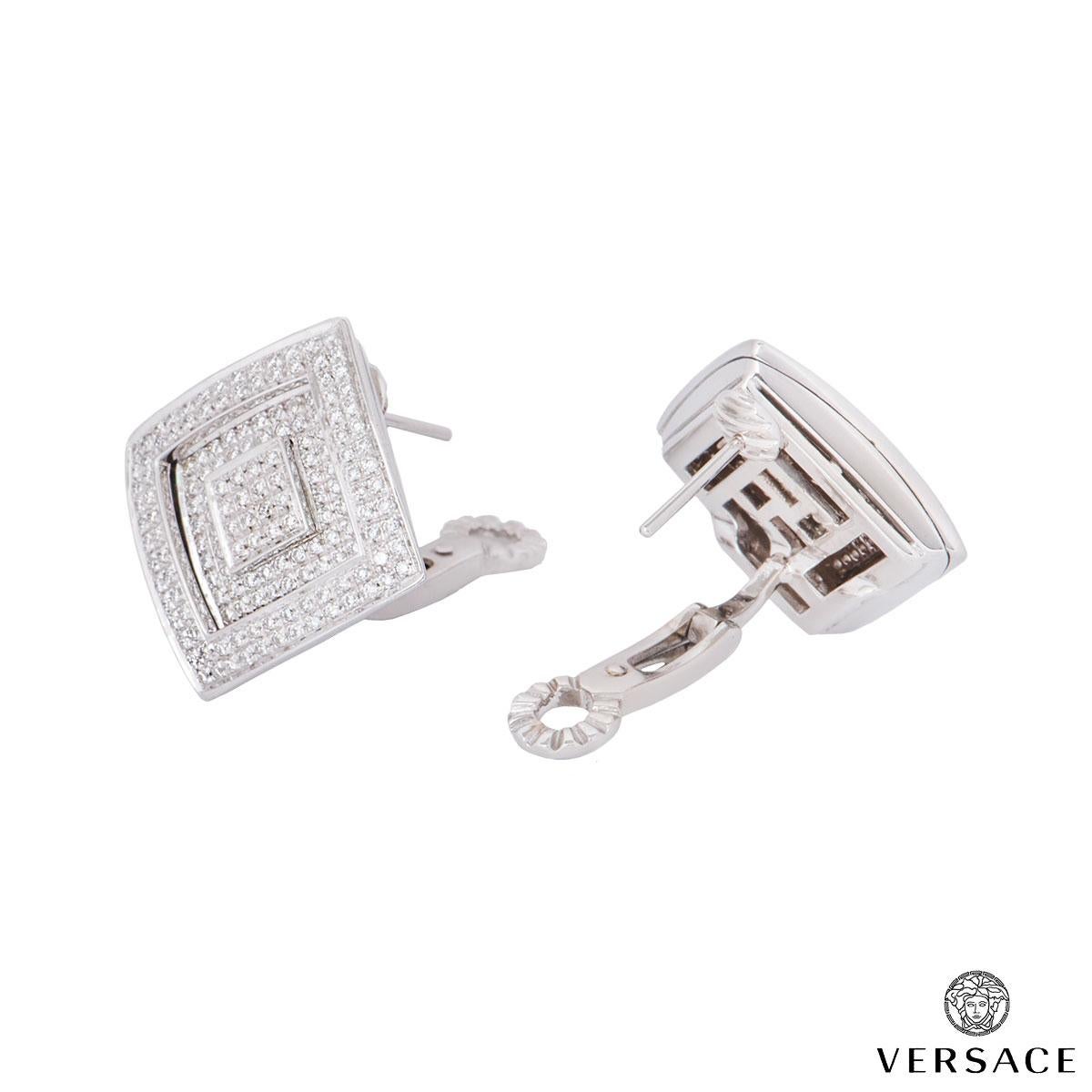 A pair of 18k white gold diamond earrings by Versace. The earrings feature pave set round brilliant cut diamonds in a square design with an embossed square in the centre with an approximate weight of 1.10ct. The earrings feature a post and lever