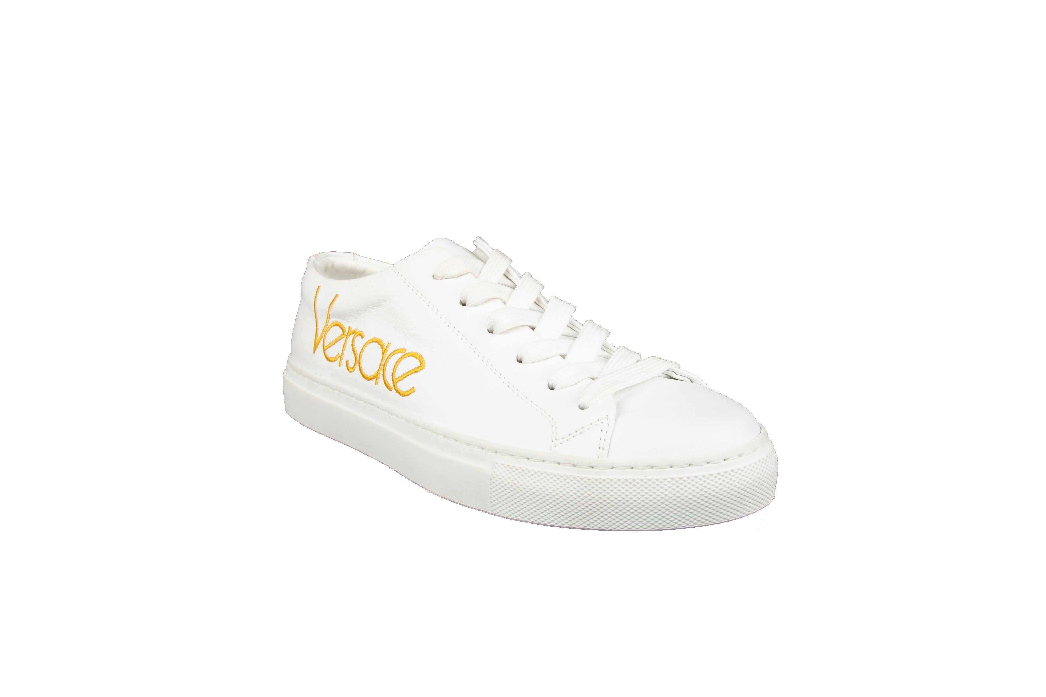 Crafted in Italy, these white leather sneakers from Versace feature a round toe, a lace-up front fastening, a branded insole and a yellow embroidered 