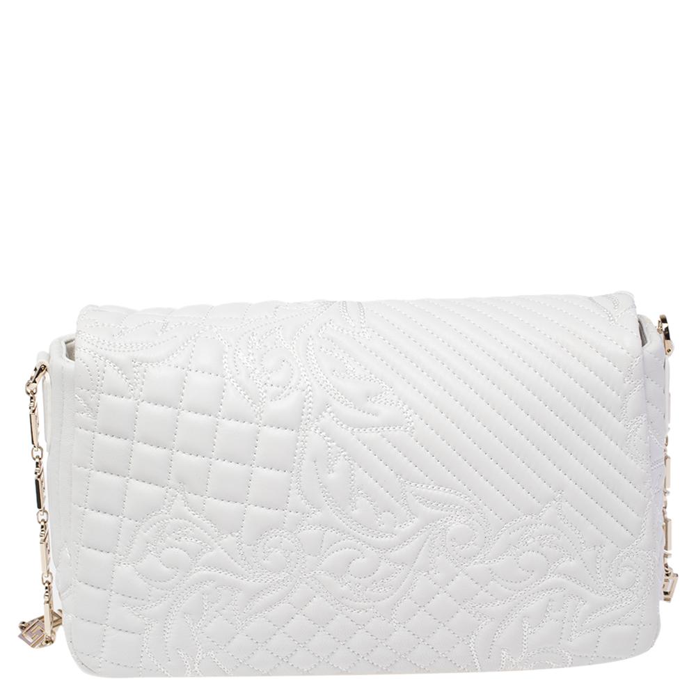 How gorgeous is this Vanitas Medea bag from Versace! Crafted from white leather, it carries a Barocco quilted design. The front flap flaunts the signature Medusa logo, a tassel charm and opens to a satin interior that can easily accommodate your