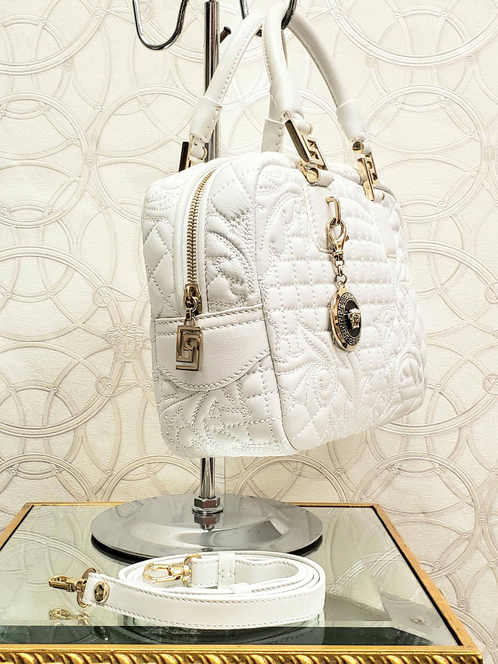 VERSACE 


Iconic quilted leather Versace handbag 



The bag can be carried on a long belt, and can be carried by 2 short handles 



Has Identity card pocket



 Gold-tone hardware with Medusa medallion 



Content: 100%  Leather





Made in