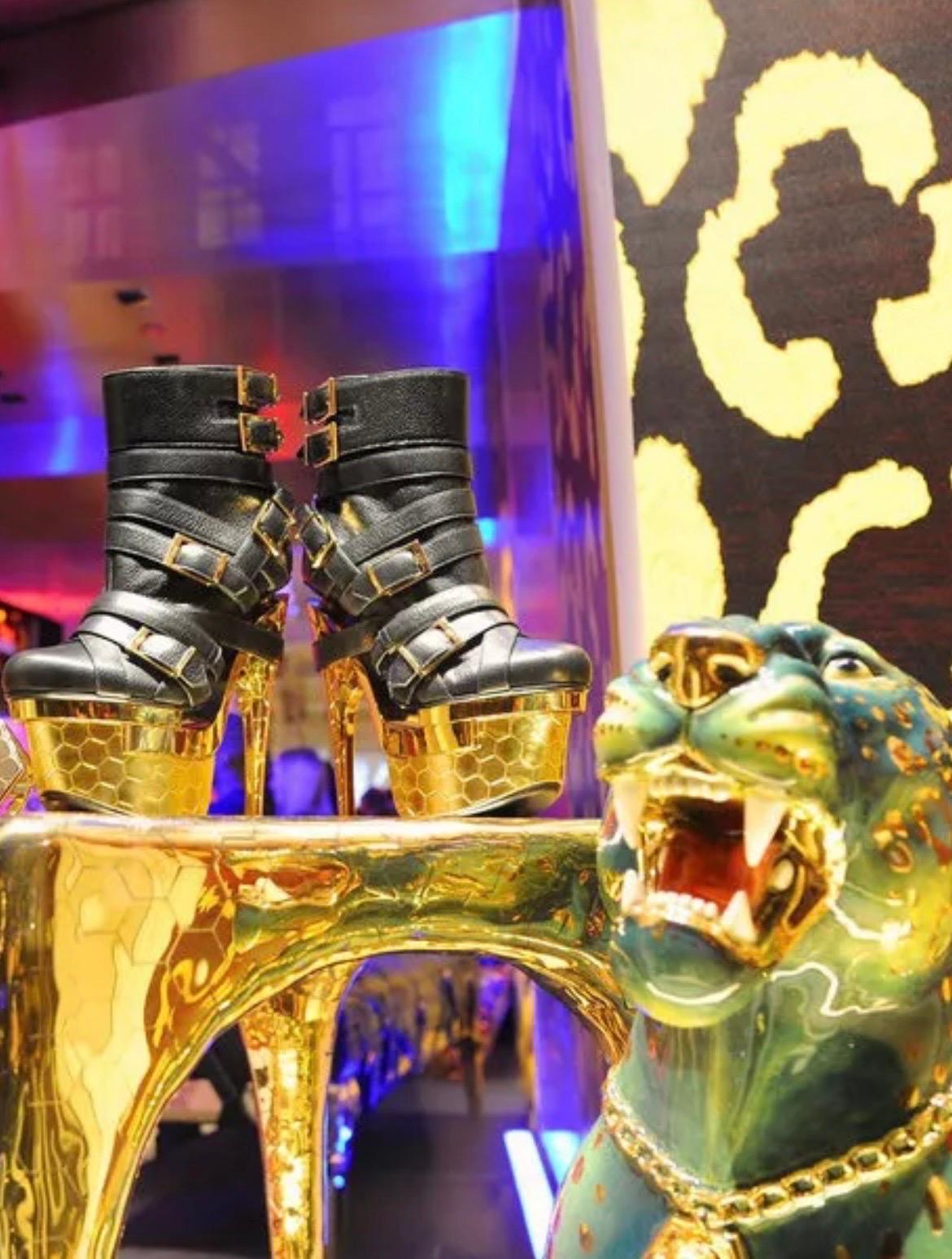 VERSACE x HAAS BROTHERS BONDAGE BOOTS

An ultra-rare collector’s piece from the iconic collaboration between Versace and Haas Brothers. These triple platform ankle boots feature:
	•	Smooth black leather with bold gold-tone buckles, exuding power and