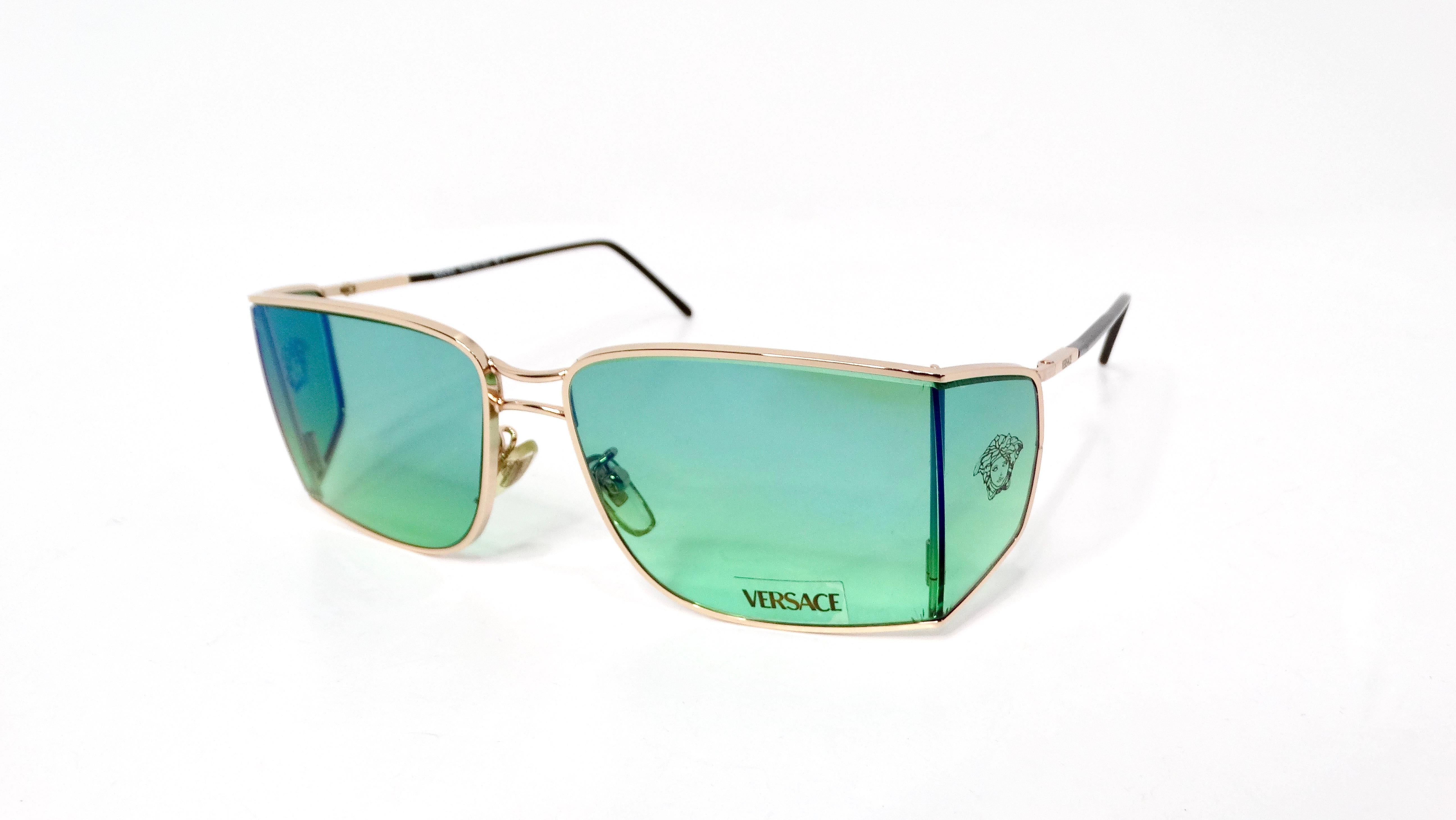 Introducing the Versace X47 Green & Blue Ombre Sunglasses, where Italian luxury meets bold fashion. These striking sunglasses feature a stunning gradient design that transitions seamlessly from rich green to vibrant blue, making them a standout