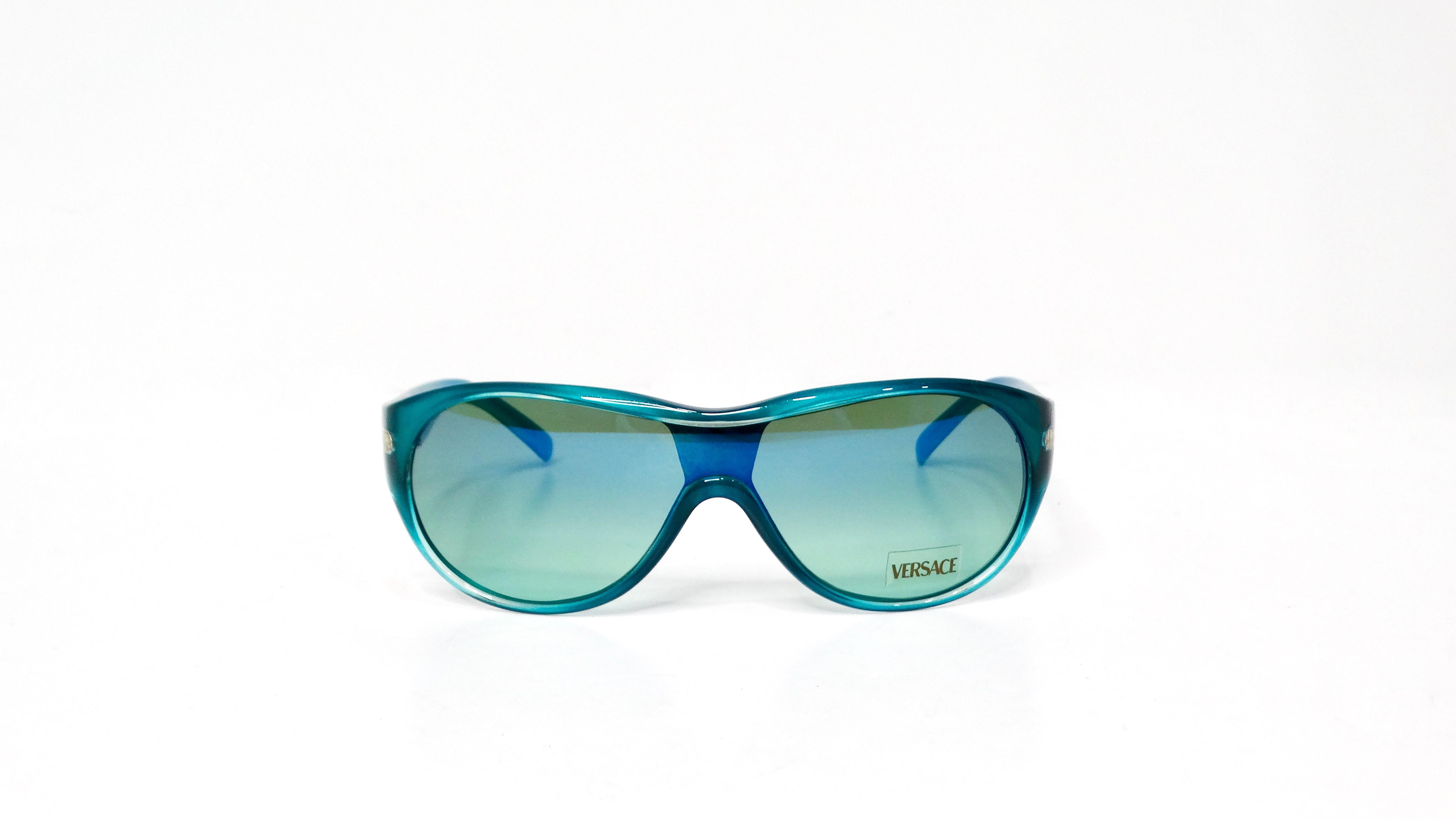 Elevate your accessory game with the Versace Y2K 439 Teal Gradient Shield Sunglasses, a bold fusion of retro and modern aesthetics. Showcasing an eye-catching teal gradient shield design, these sunglasses provide a striking visual appeal that