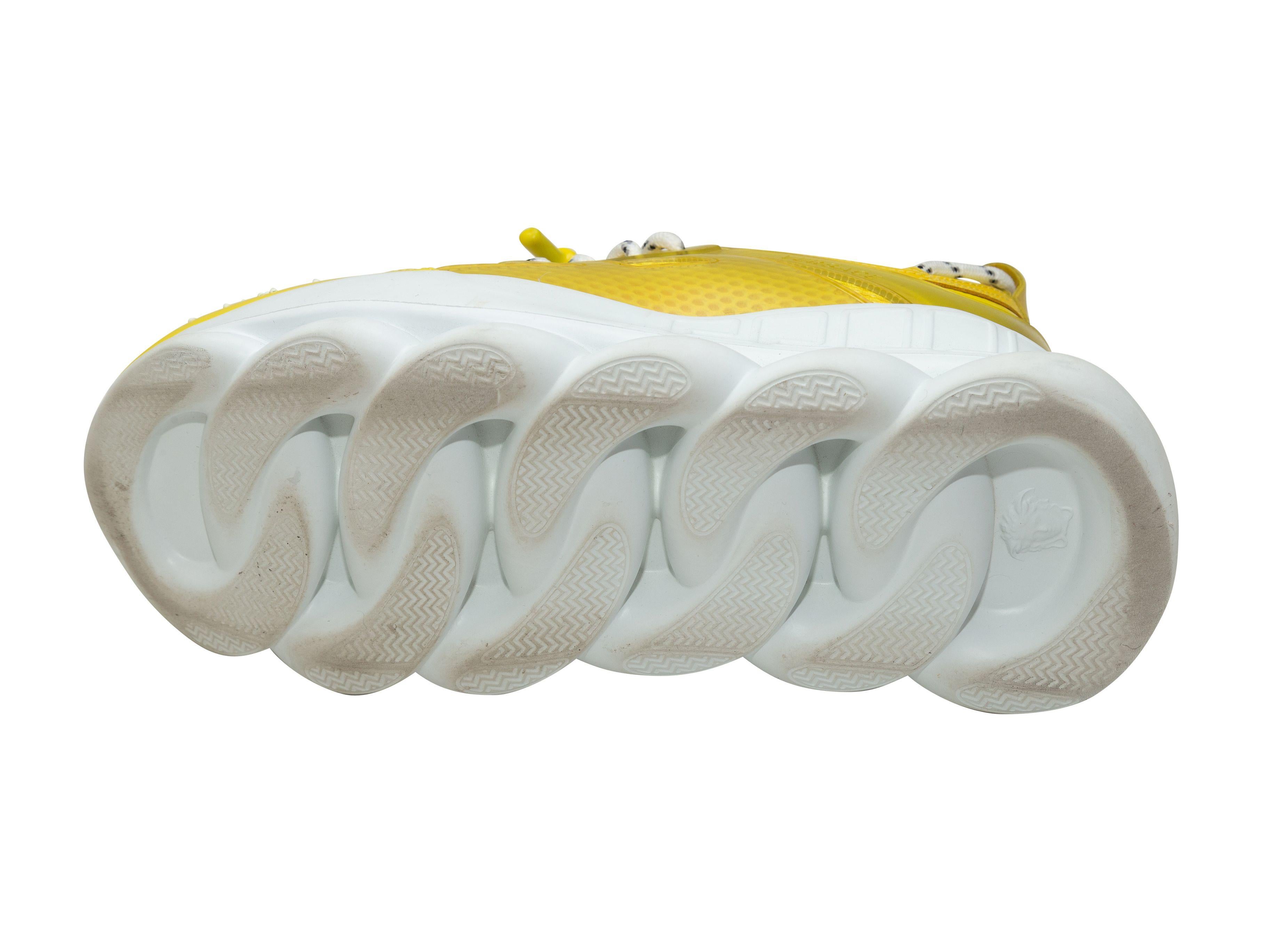 Product Details: Yellow nylon and leather chunky low-top sneakers by Versace x Chain Reaction. White foam rubber soles. Lace-up tie closures at tops. 2