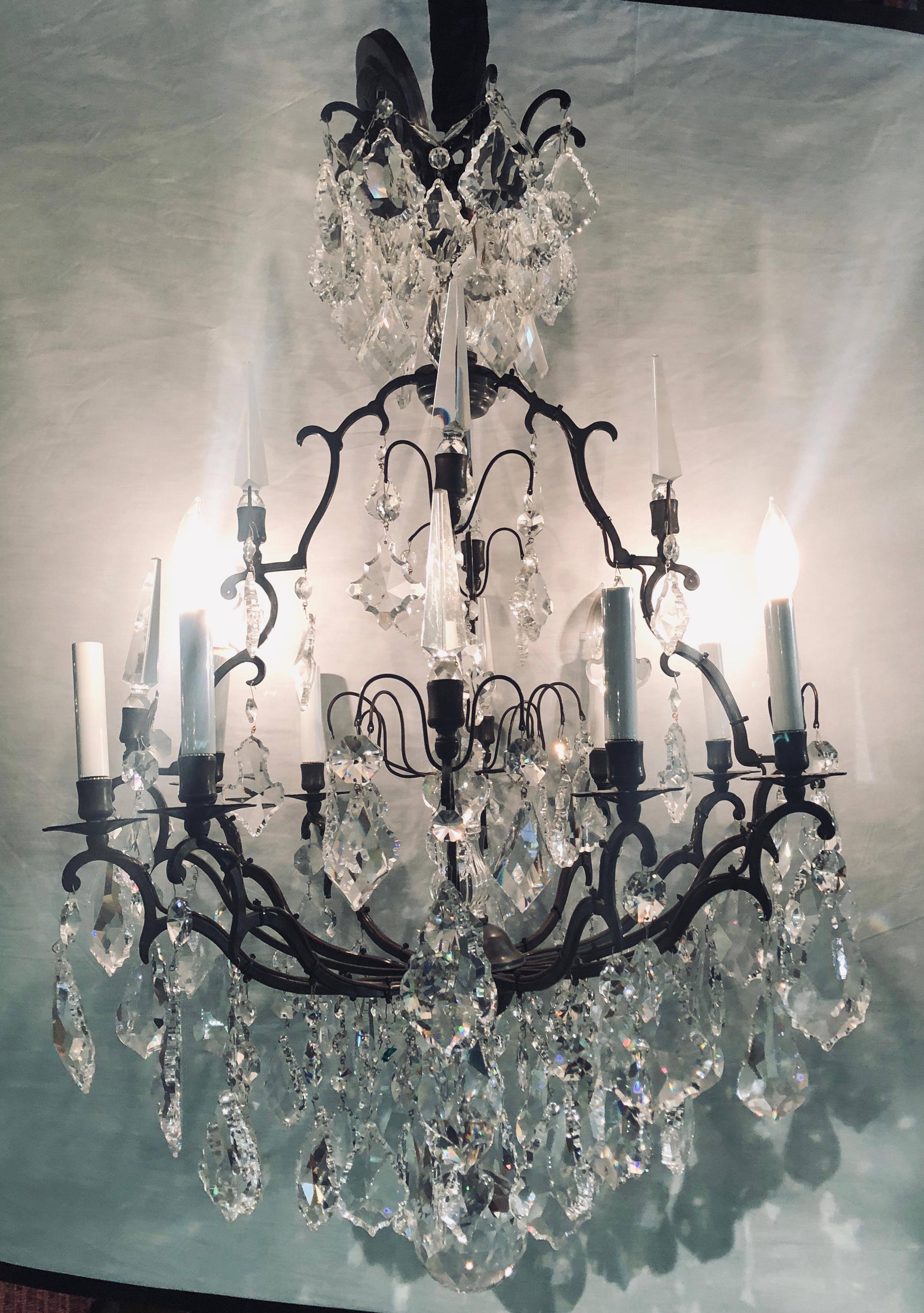 Versailles chandelier with Swarovski Strass and crystal pendants having a dark brownish almost black iron frame. Recently rewired. Ready to hang in your home or office.