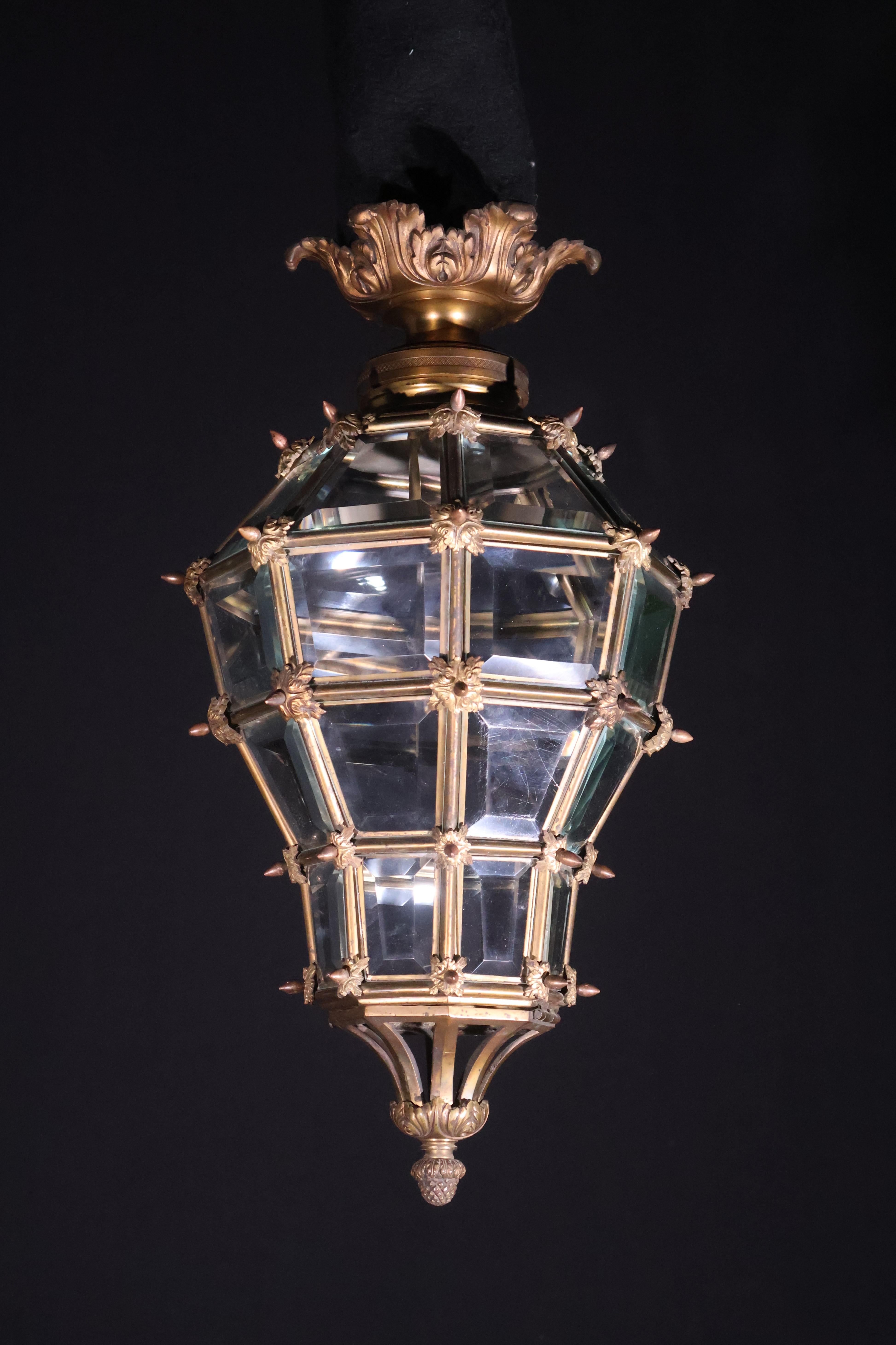An Exquisite Gilt Bronze Lantern. Original gilding. Having individual beveled glass panels. Based on the lantern at Versailles. France, circa 1910. 1 light. 
Dimensions: Height 21