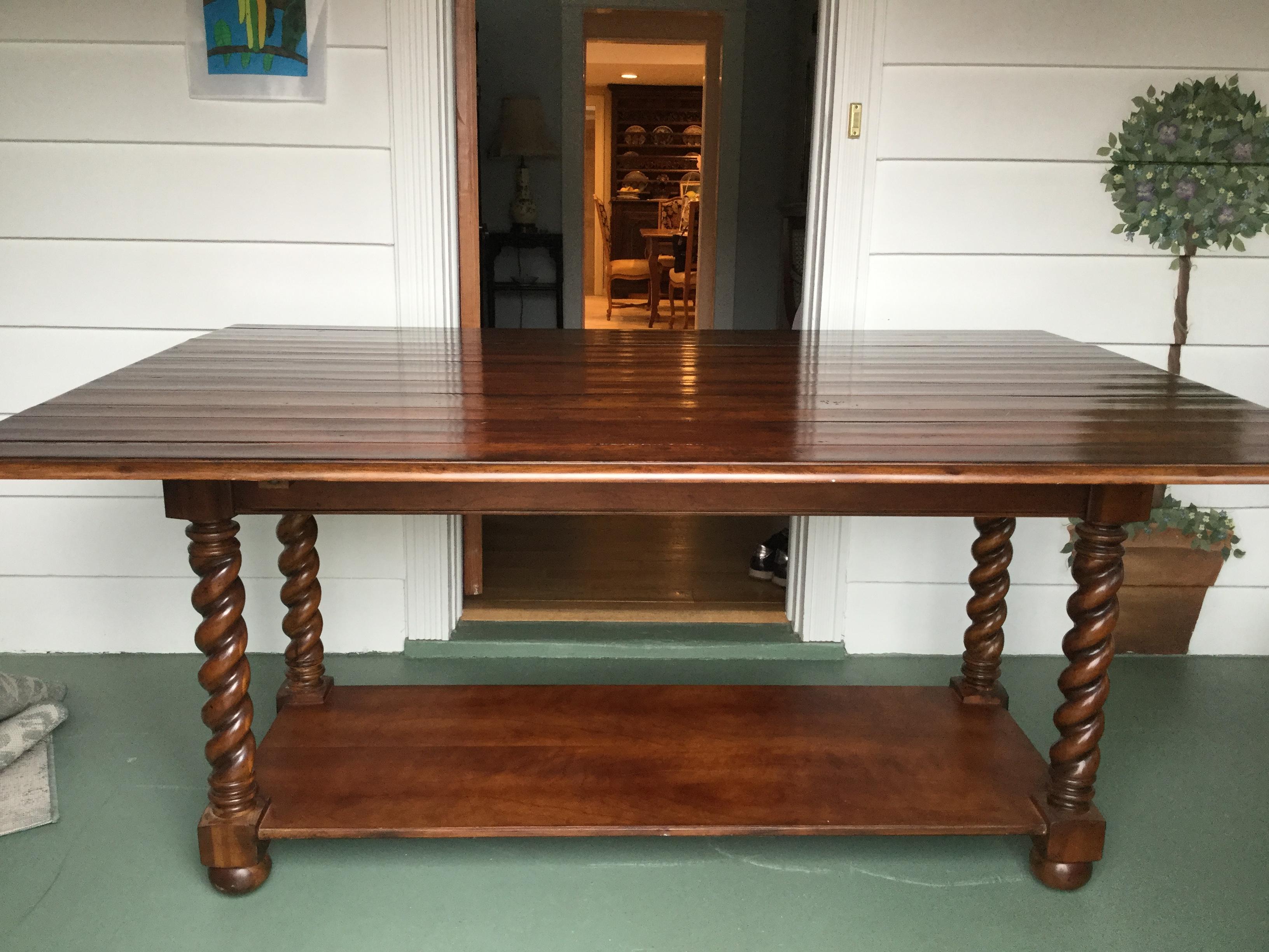 Handsome cherry farm table with gorgeous patina having two drop leaves that makes it very versatile for a narrow space. Only 24 inches deep when leaves are down. Made of rich cherry wood planks, this table sits on stunning barley-twist legs and is