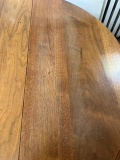 Versatile Antique Walnut Oval Drop Leaf Dining Table