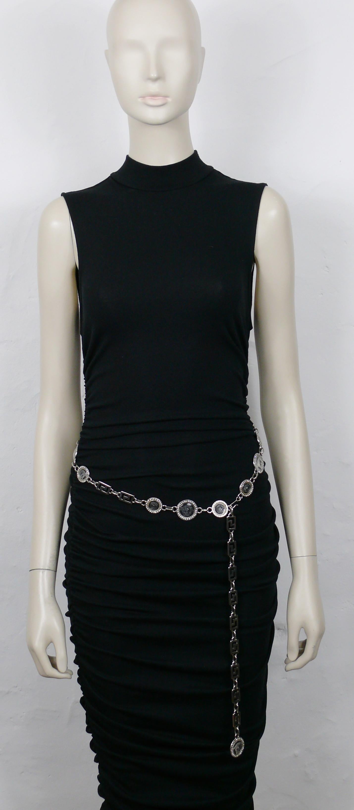 VERSATILE by GIANNI VERSACE vintage iconic silver tone belt featuring greek key links and clear resin Medusa coins embellished with clear crystals.

Hook clasp closure
Adjustable length.

Embossed GV VERSATILE.

Indicative measurements : wearable