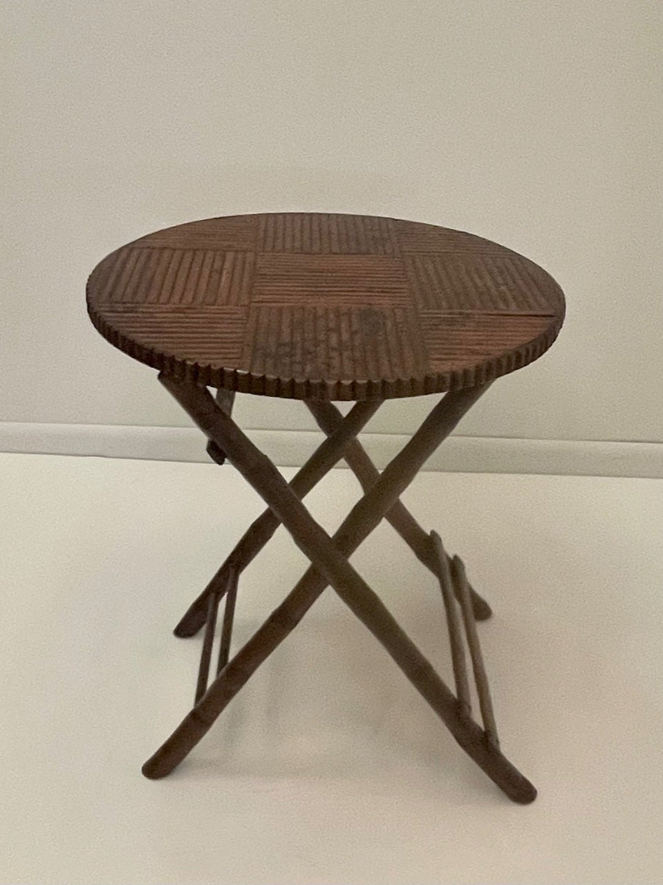 A great looking versatile folding bamboo round side table having handsome geometric design on top and a honey brown warm patina.
Note:  Pair available for $2200