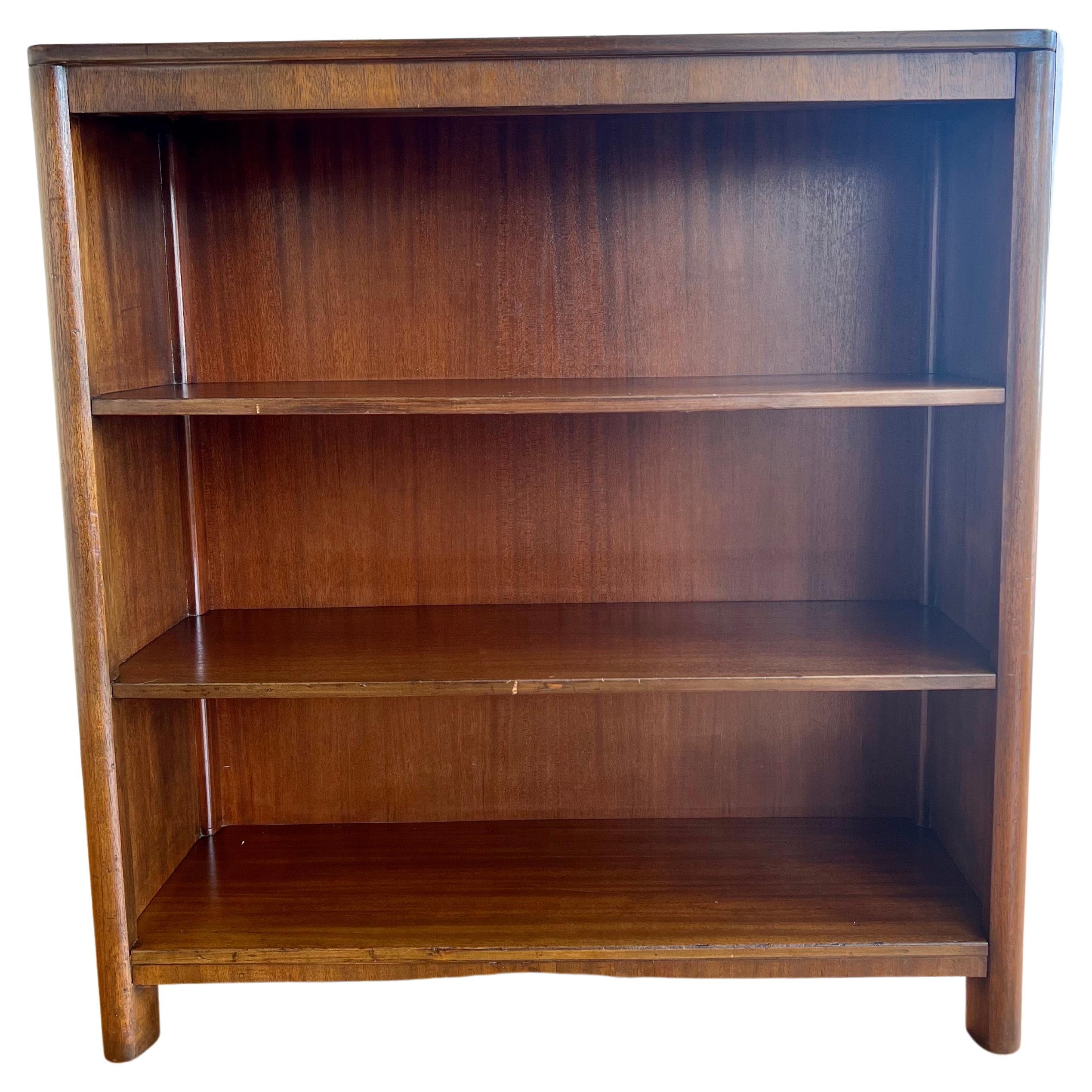 Versatile low bookcase in walnut finish with mahogany construction circa 1940's solid and sturdy with a 10
