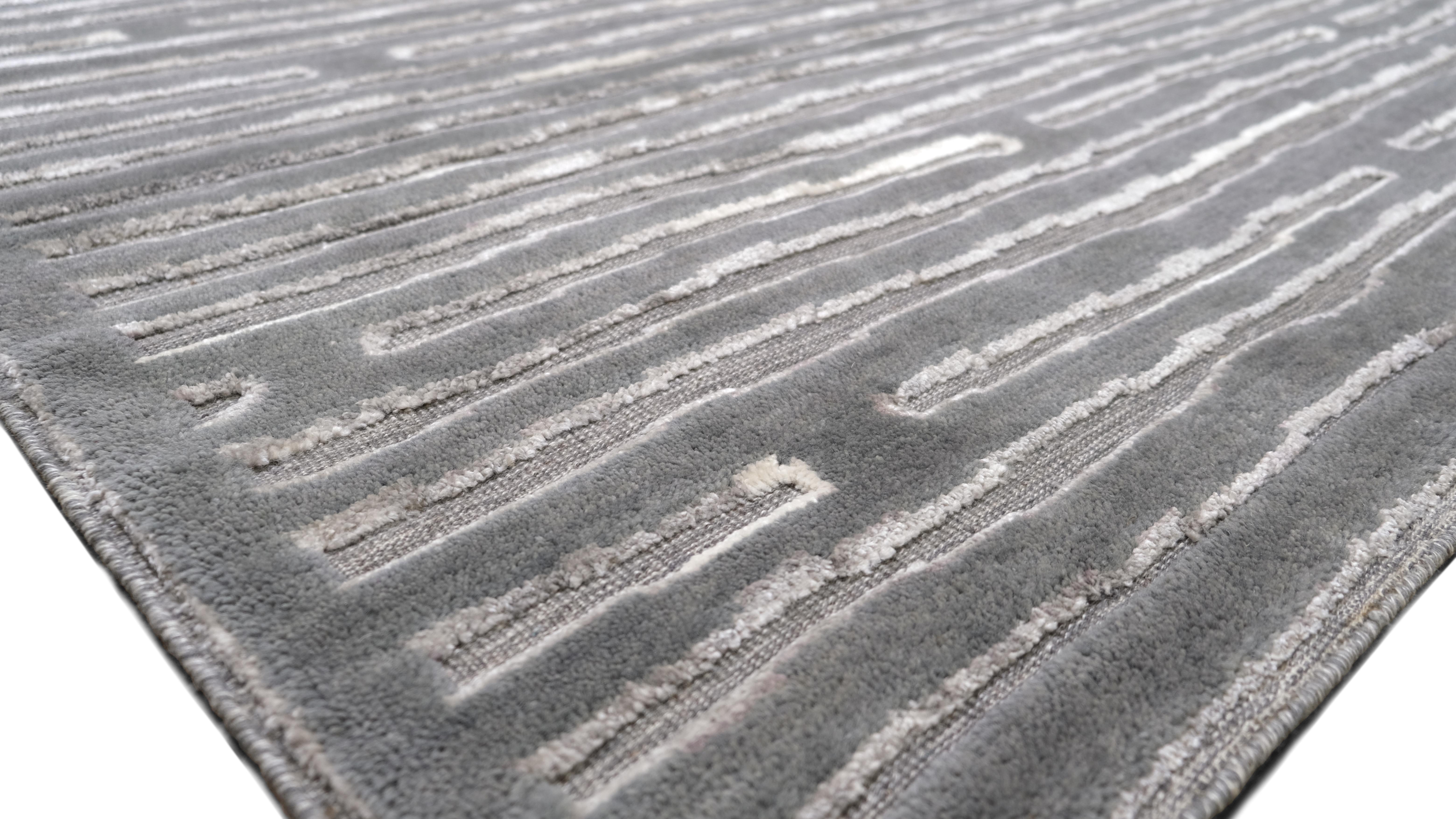 Dieser moderne, handgeknüpfte Wollteppich wertet Ihren Raum mit seiner zeitlosen Ausstrahlung auf. Mit seinem linearen Bewegungsmuster eignet sich dieses Stück perfekt für die Schaffung eines ruhigen und anspruchsvollen Ambientes in