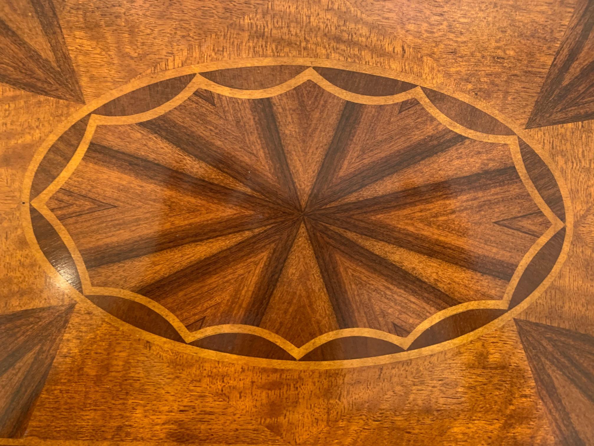 Very refined 3-tier mahogany side table or étagère having oval central inlaid medallions on each surface, handsome acorn shaped finials, and elegant brass legs that terminate in brass casters. The legs and surrounds on each tier have a bronze patina.