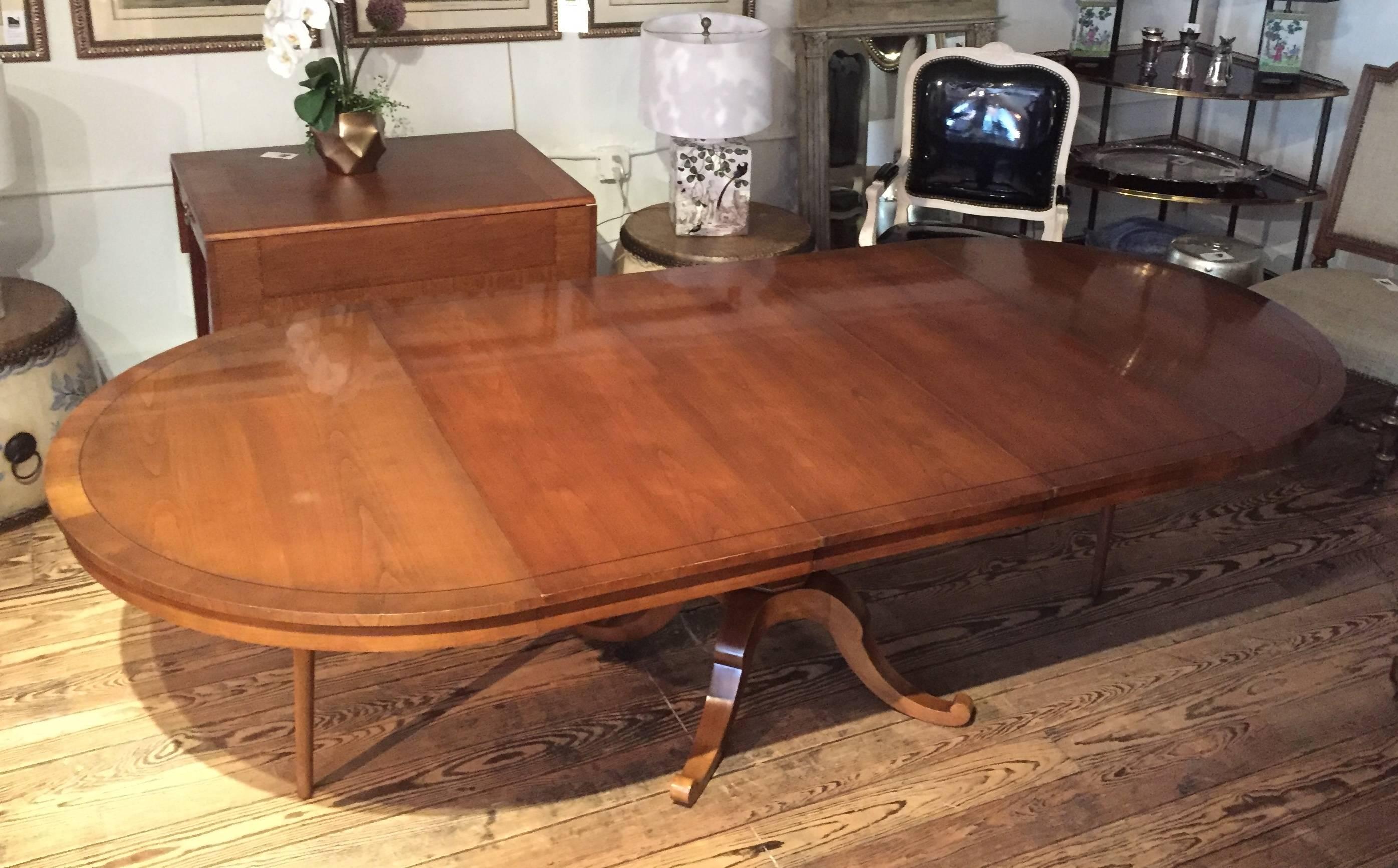 Fabulously expandable or shrinkable dining table,...4 ft round at its smallest, and then ingeniously pulls apart to make room for three leaves to create an elegant very long oval. Each leaf is 18 inches.  Has just been restored so in beautiful