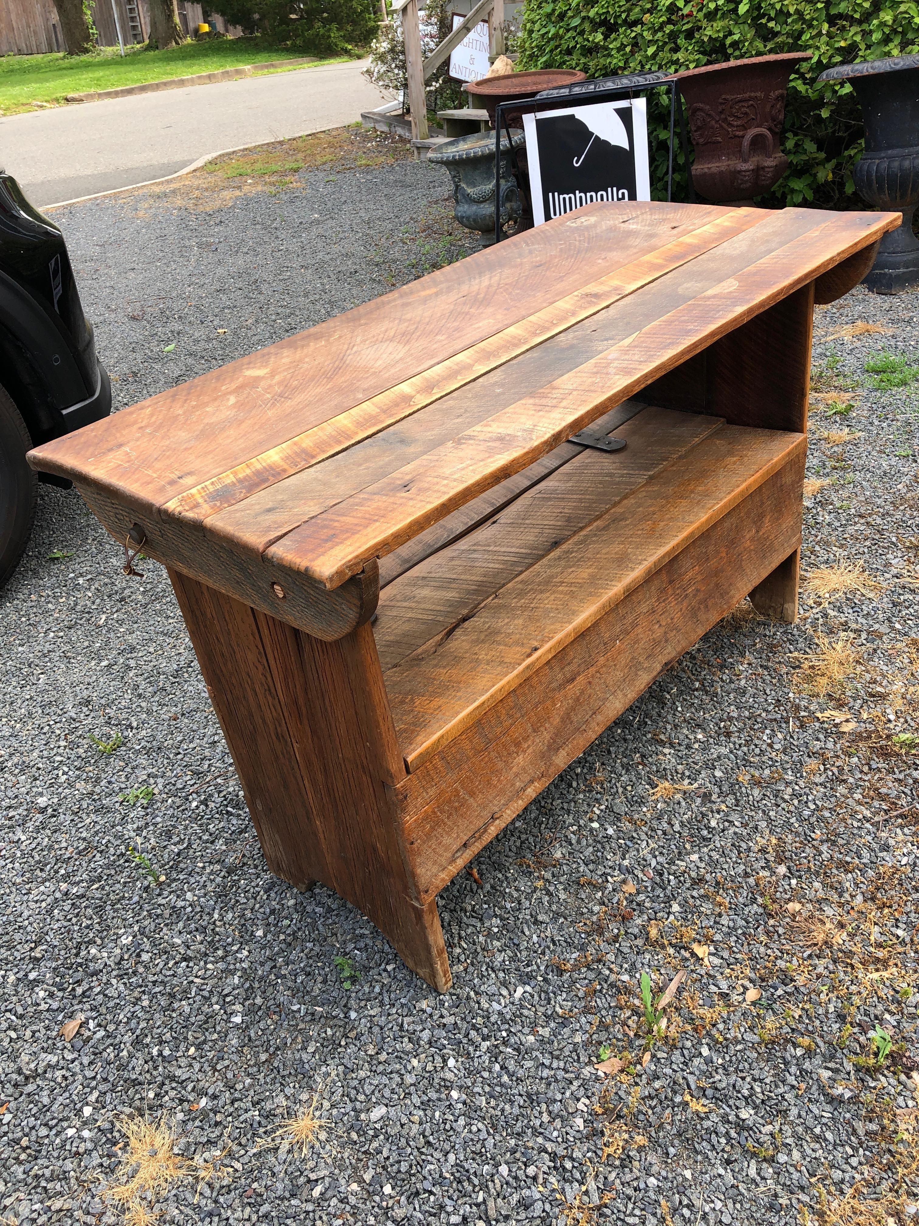 An antique rustic multi use pine table hutch that functions both as a table in one position and a mud room bench with storage inside.
Table 45.5 L, 22.25 D, 29 H
with top in up position 42