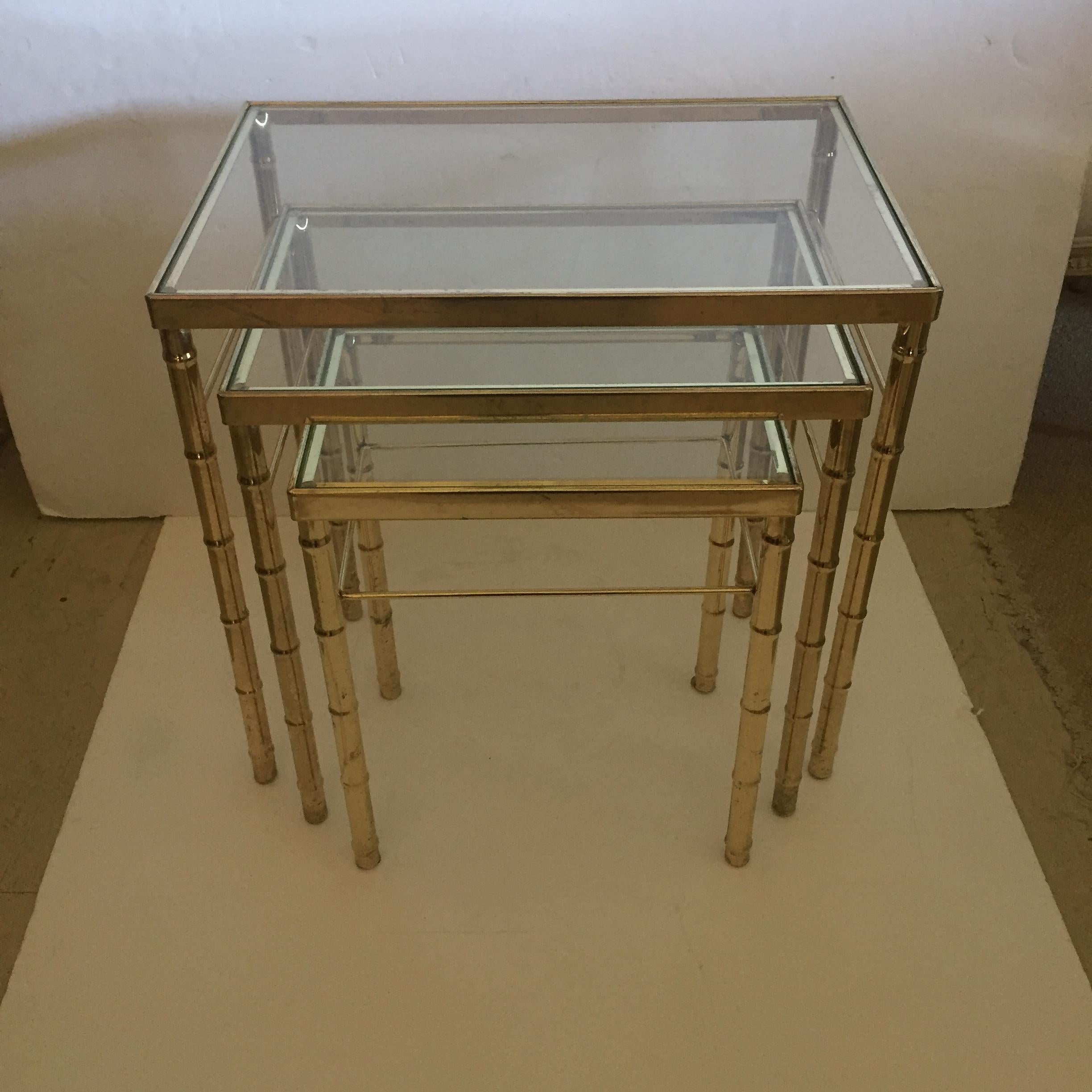 Measures: Large table
15 1/2” x 22 1/2”
Handsome set of three Mid-Century Modern nesting tables with faux bamboo style brass legs and glass tops in graduated sizes.
Measures: Medium table
19 high 12 1/2 x 18 1/2
Small table
17 high 9 1/2 x 14