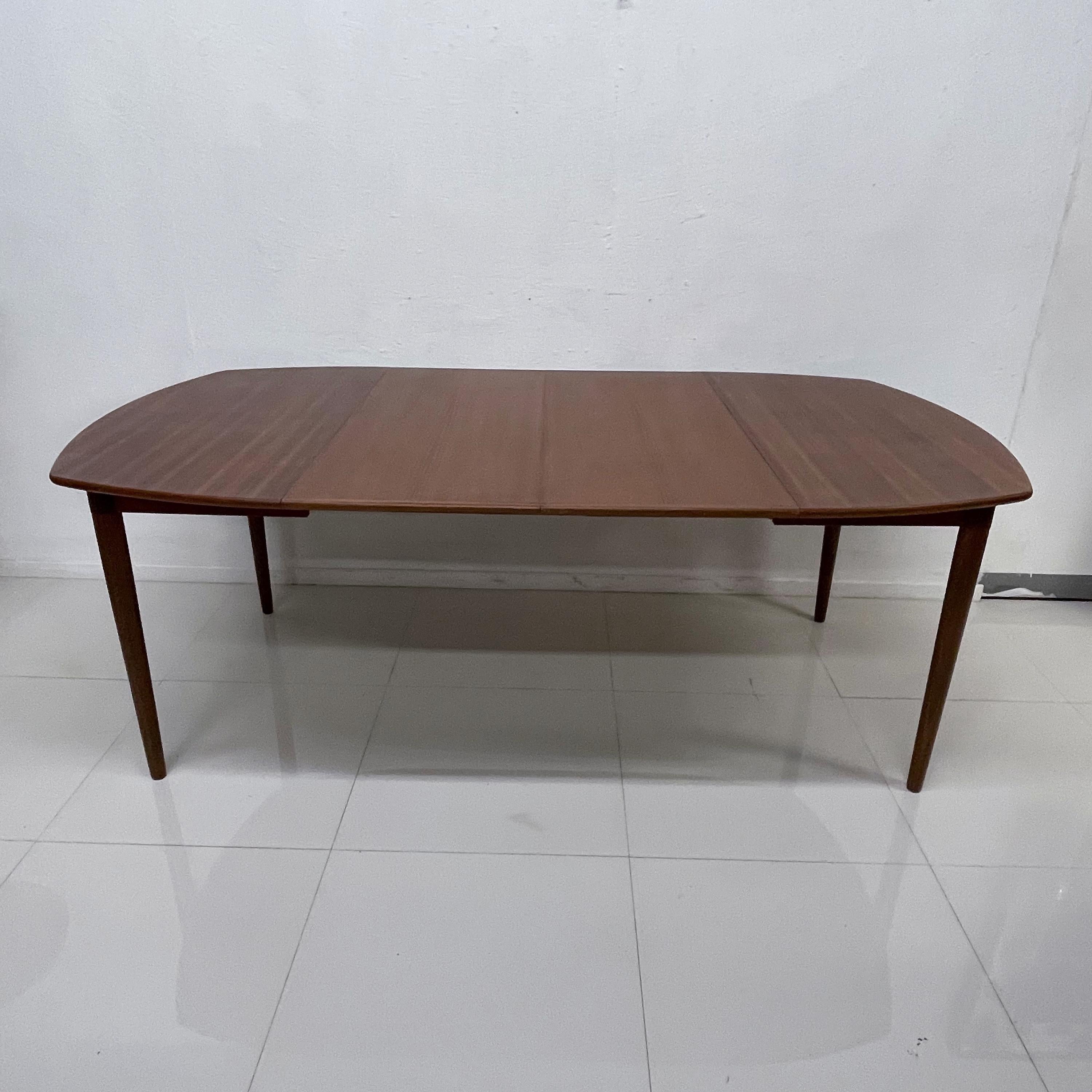 Restored Scandinavian Modern Teak Dining Table.
Versatile shape.
Tapered legs.
Two Extensions.
No stamp. Attribution Arne Vodder.
Firm and sturdy vintage. 
Original Vintage Preowned condition.
Refer to our images.
79 L Fully extended 61 with one