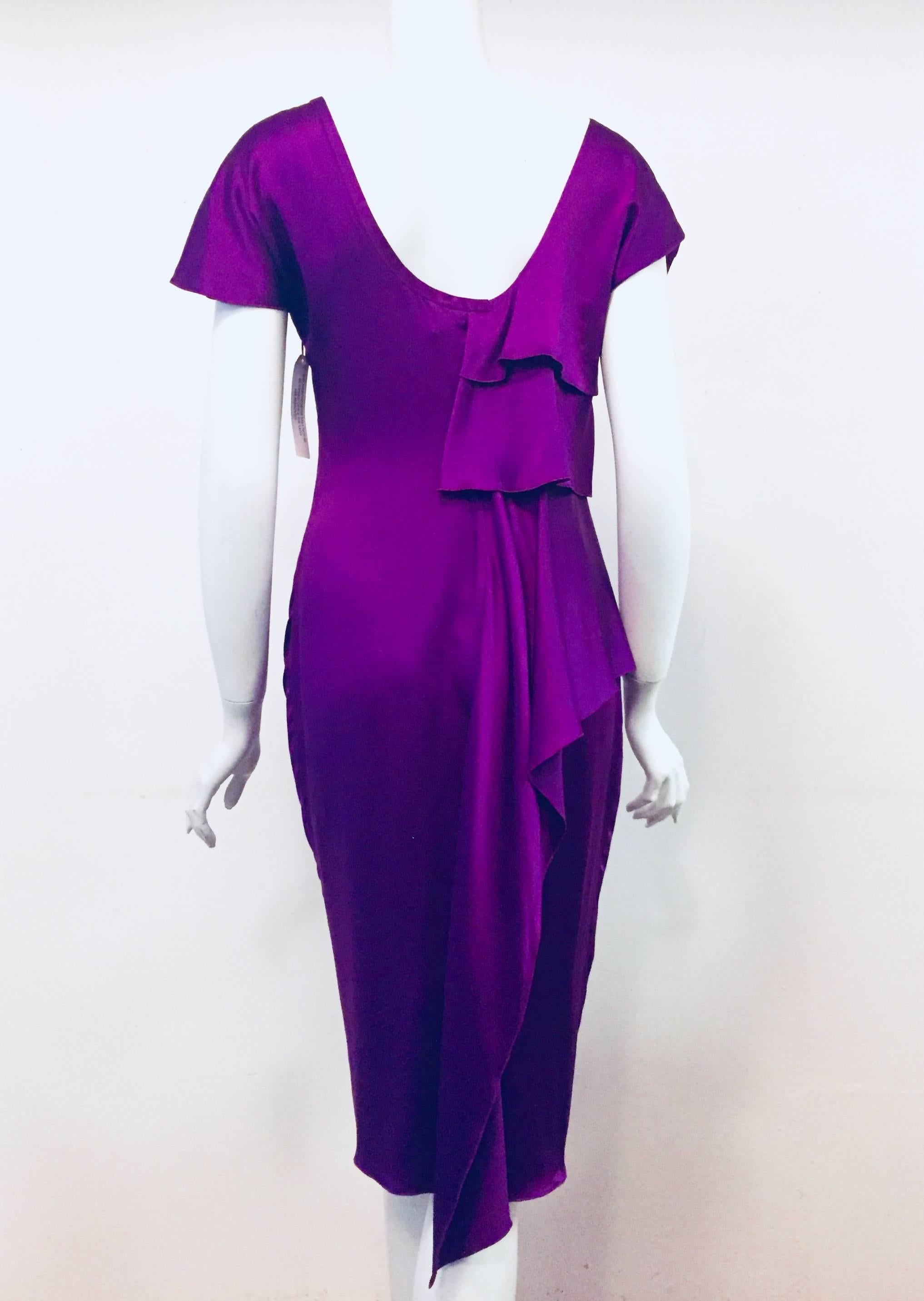 Versace was celebrated for his glamorous designs and impeccable craftsmanship which still continues with the house of Versace. This purple silk draped dress is cut in a figure flattering silhouette featuring short sleeves that convert into ruffles