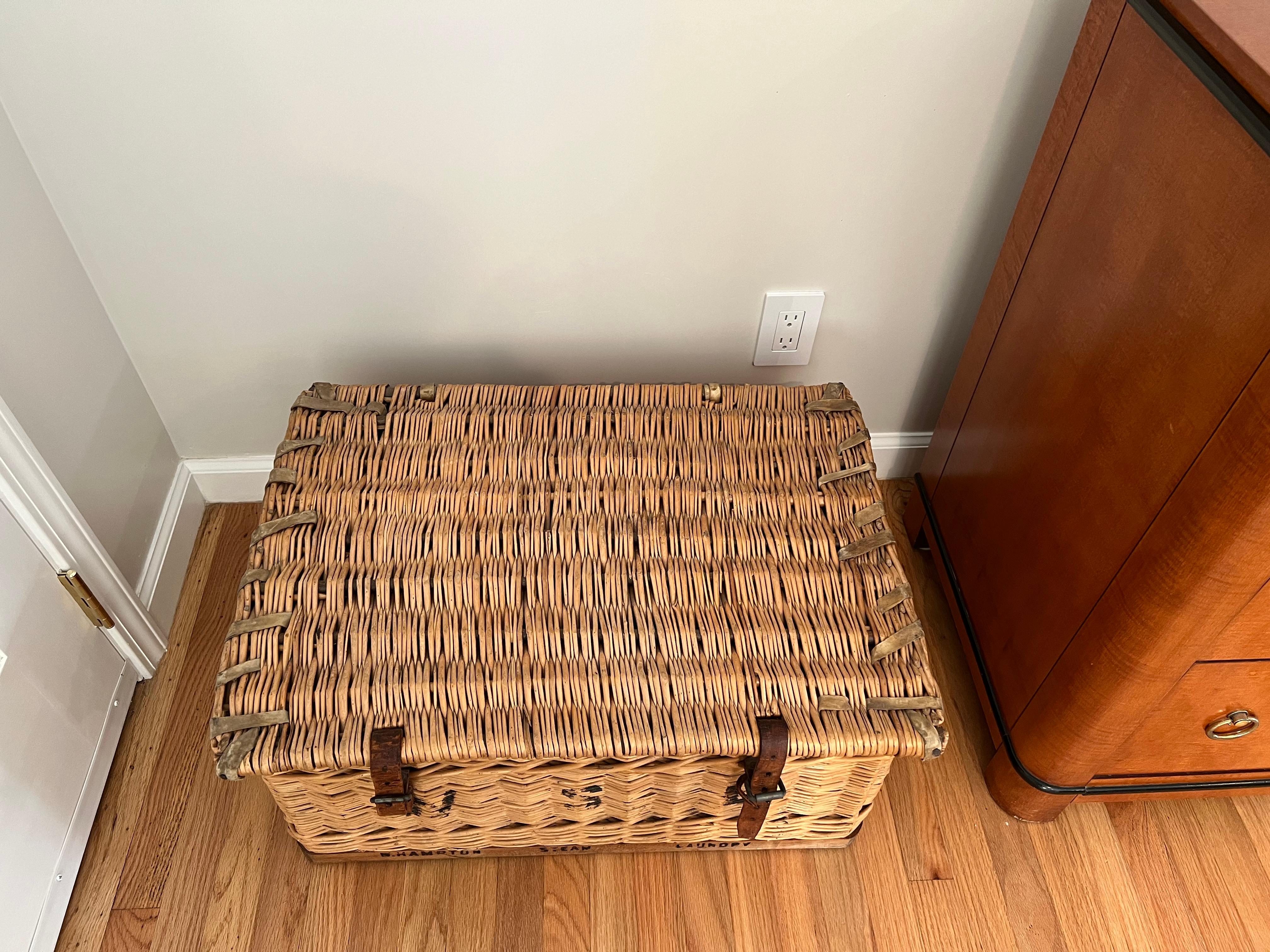 Great looking functional vintage wicker laundry trunk basket, formerly used as a handsome coffee table with storage inside. Cool black graphic numbers and lettering on the trunk adds to the authentic look.