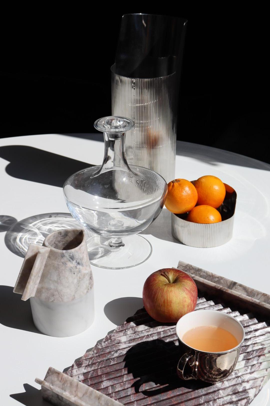 Patricia Urquiola's unmistakable distinguishing feature is reported on a series of water carafes and trays hand made in Italy in marble.