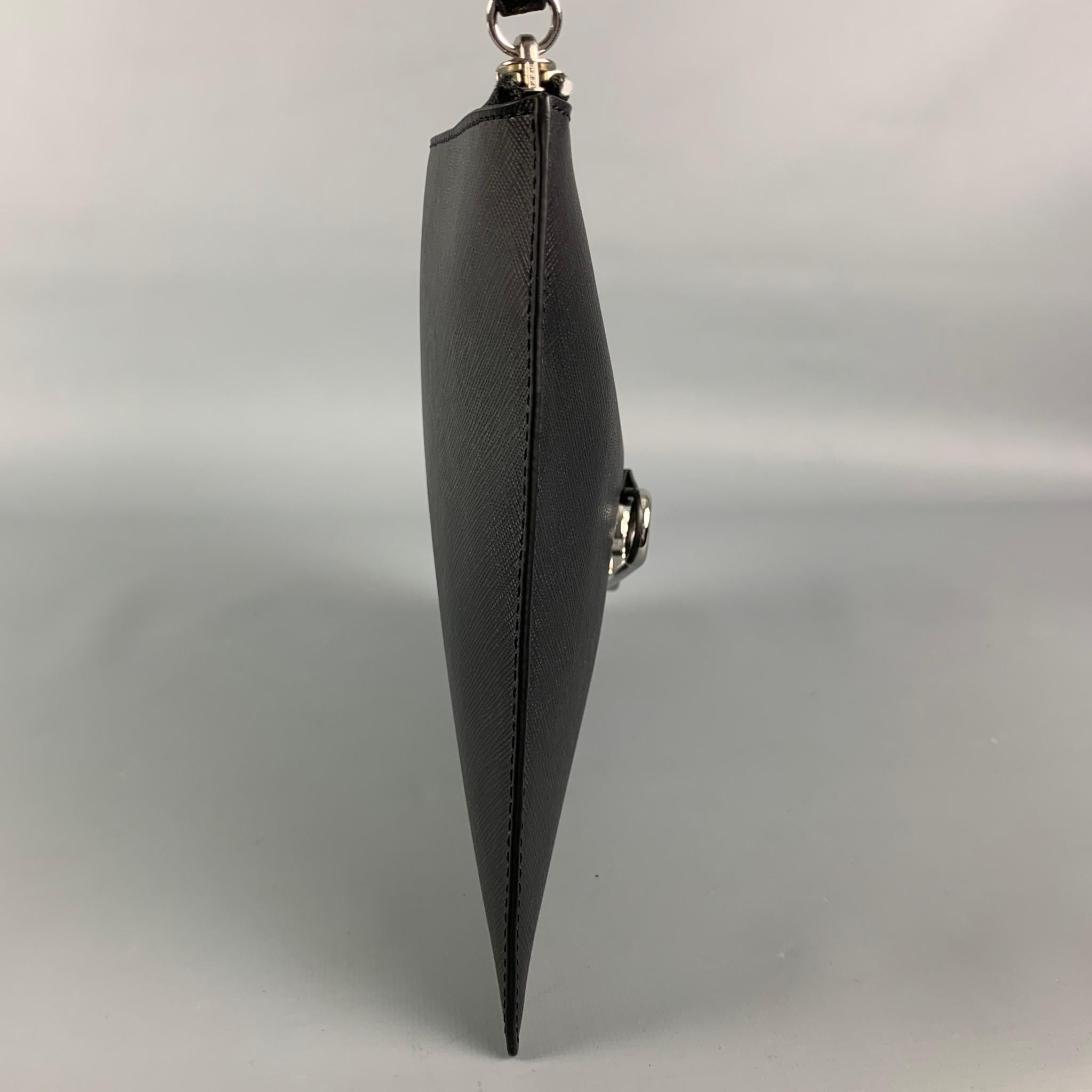 VERSUS by GIANNI VERSACE wristlet comes in a black leather featuring a large safety pin logo design, wrist strap, and a zipper closure. 

Excellent Pre-Owned Condition.

Measurements:

Length: 11 in.
Height: 8 in.
Drop: 6 in. 