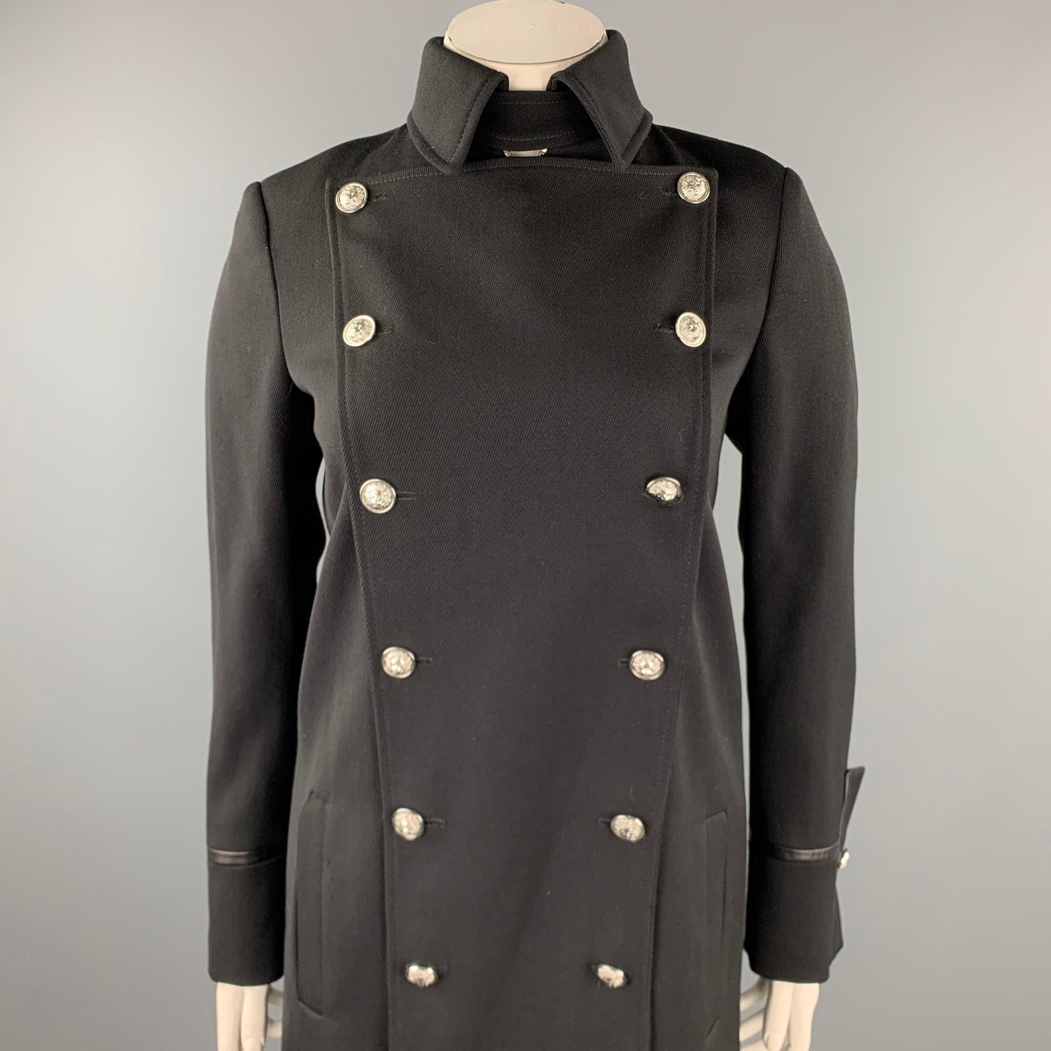 VERSUS by GIANNI VERSACE coat comes in a black wool with a monogram print liner featuring lion head button details, leather trim, double vent, neck strap detail, and a double breasted closure. Made in Romania.

Excellent Pre-Owned Condition.
Marked: