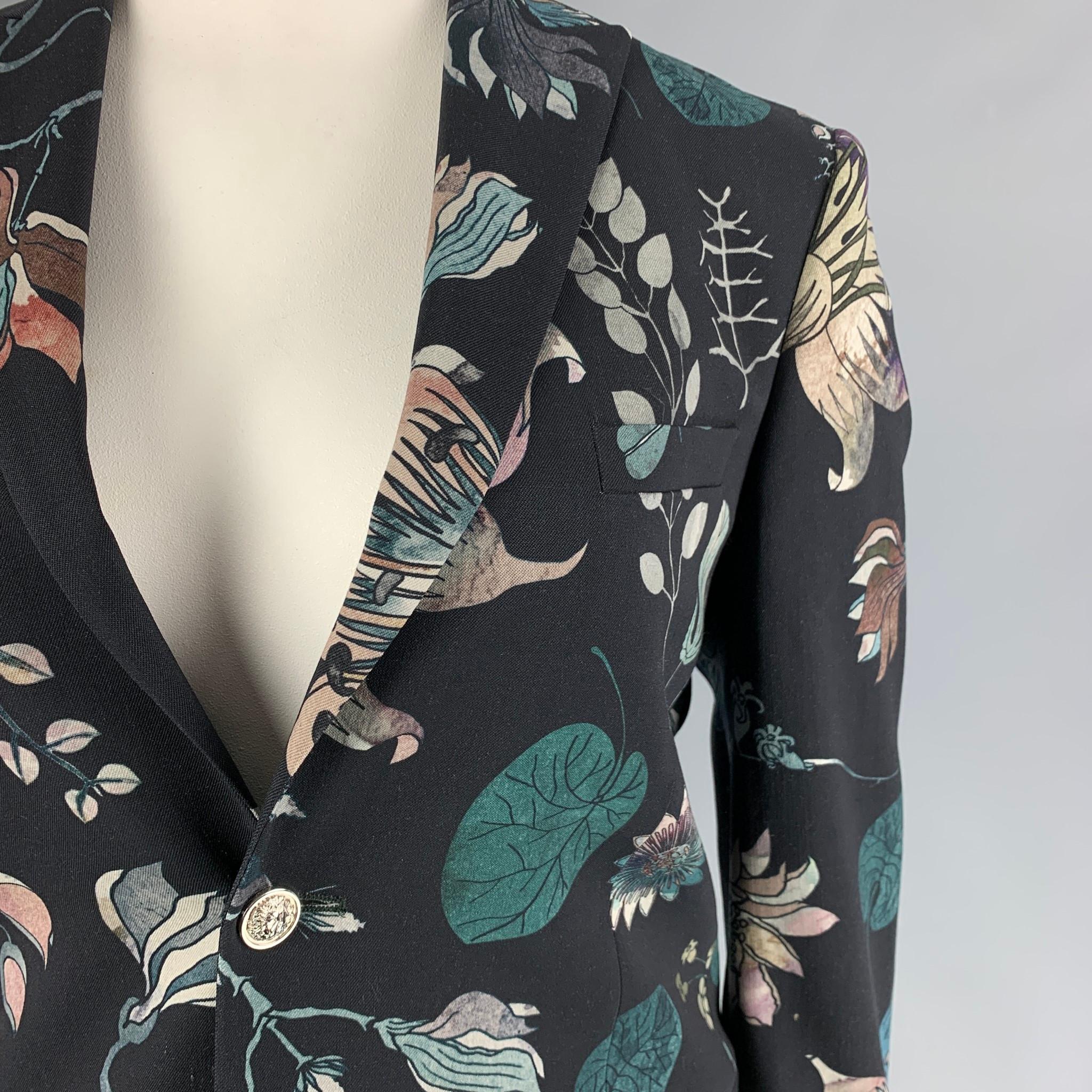 VERSUS by GIANNI VERSACE blazer comes in a multi-color print wool / elastane with a full liner featuring a peak lapel, slit pockets, double back vent, silver tone buttons, and a two button closure. Made in Romania. 

Excellent Pre-Owned