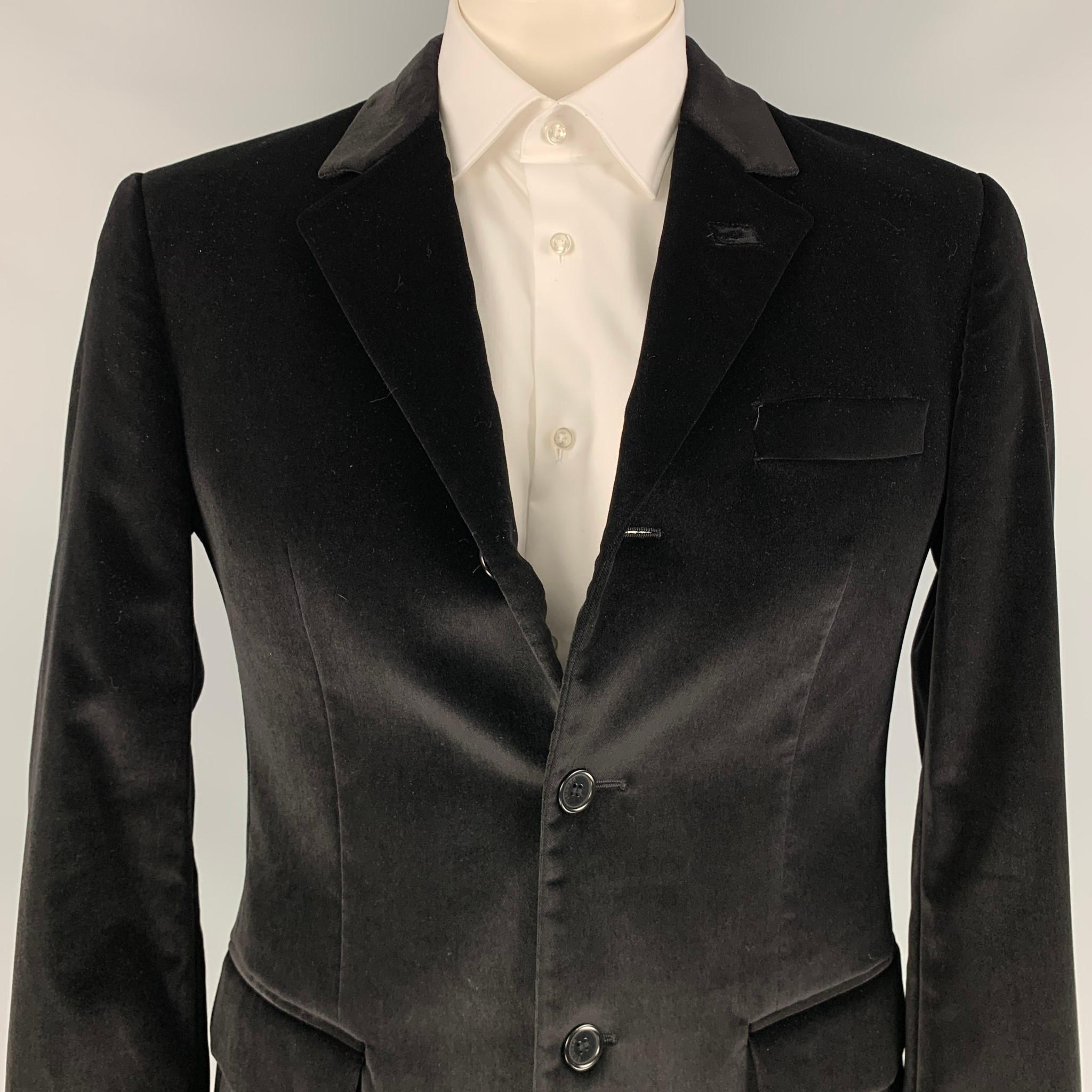 VERSUS by GIANNI VERSACE sport coat comes in a black cotton velvet with a full liner featuring a notch lapel, double back vent, flap pockets, and a three button closure. Made in Italy. 

Excellent Pre-Owned Condition.
Marked:
