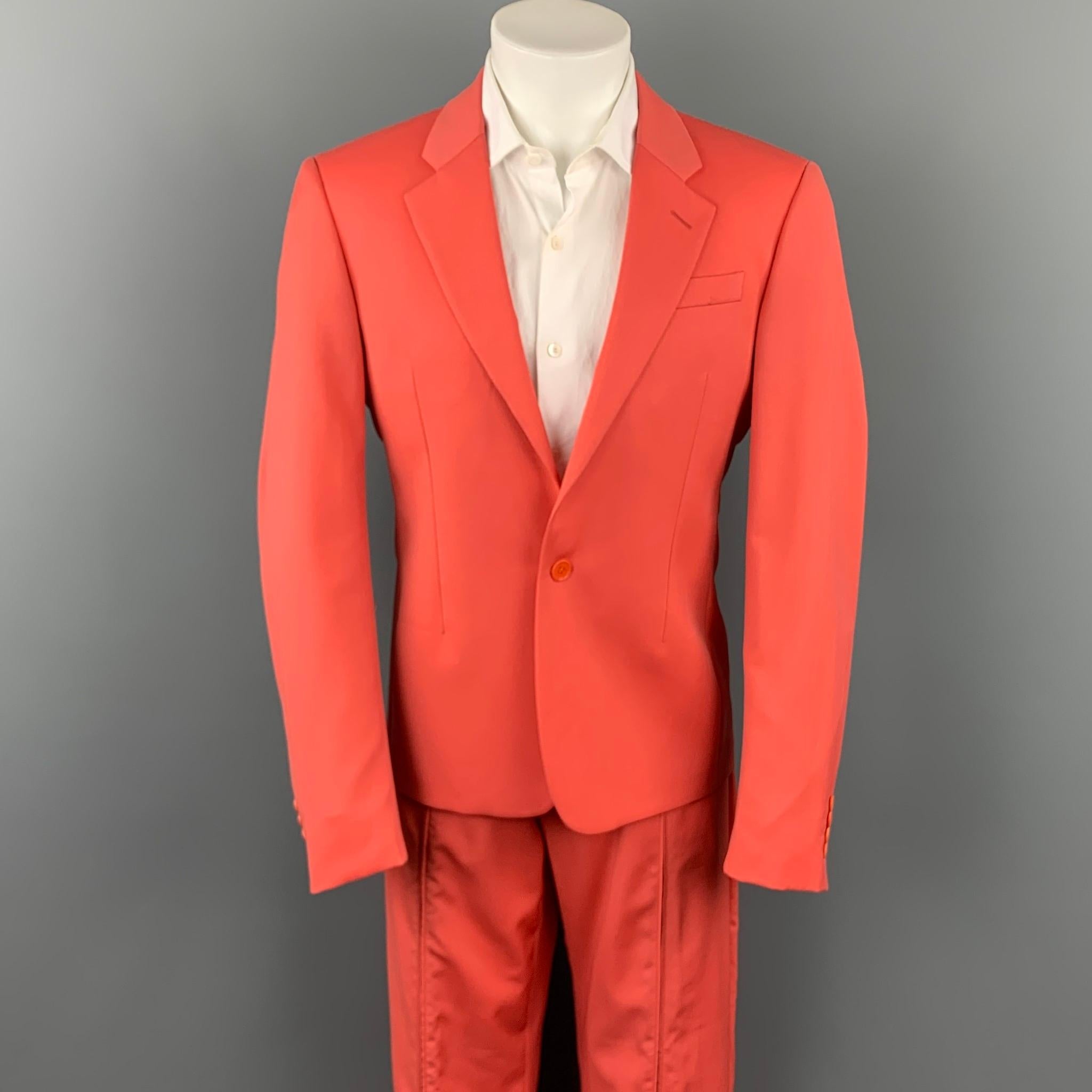 VERSUS by GIANNI VERSACE suit comes in a coral virgin wool with a full monogram print liner and includes a single breasted, single button sport coat with a notch lapel and matching trousers with a front zipper design. Made in Italy.

Very Good