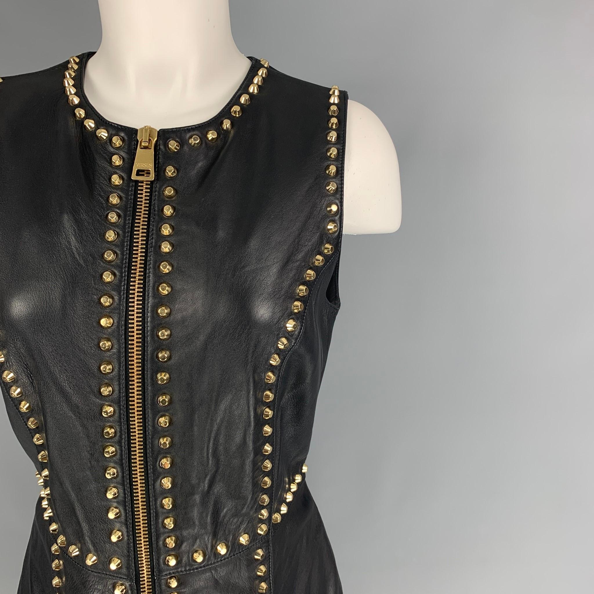 VERSUS by GIANNI VERSACE mini dress comes in a black leather featuring gold tone studded details throughout, sleeveless, and a front zipper closure. 

Very Good Pre-Owned Condition.
Marked: 42

Measurements:

Shoulder: 13 in.
Bust: 32 in.
Waist: 29
