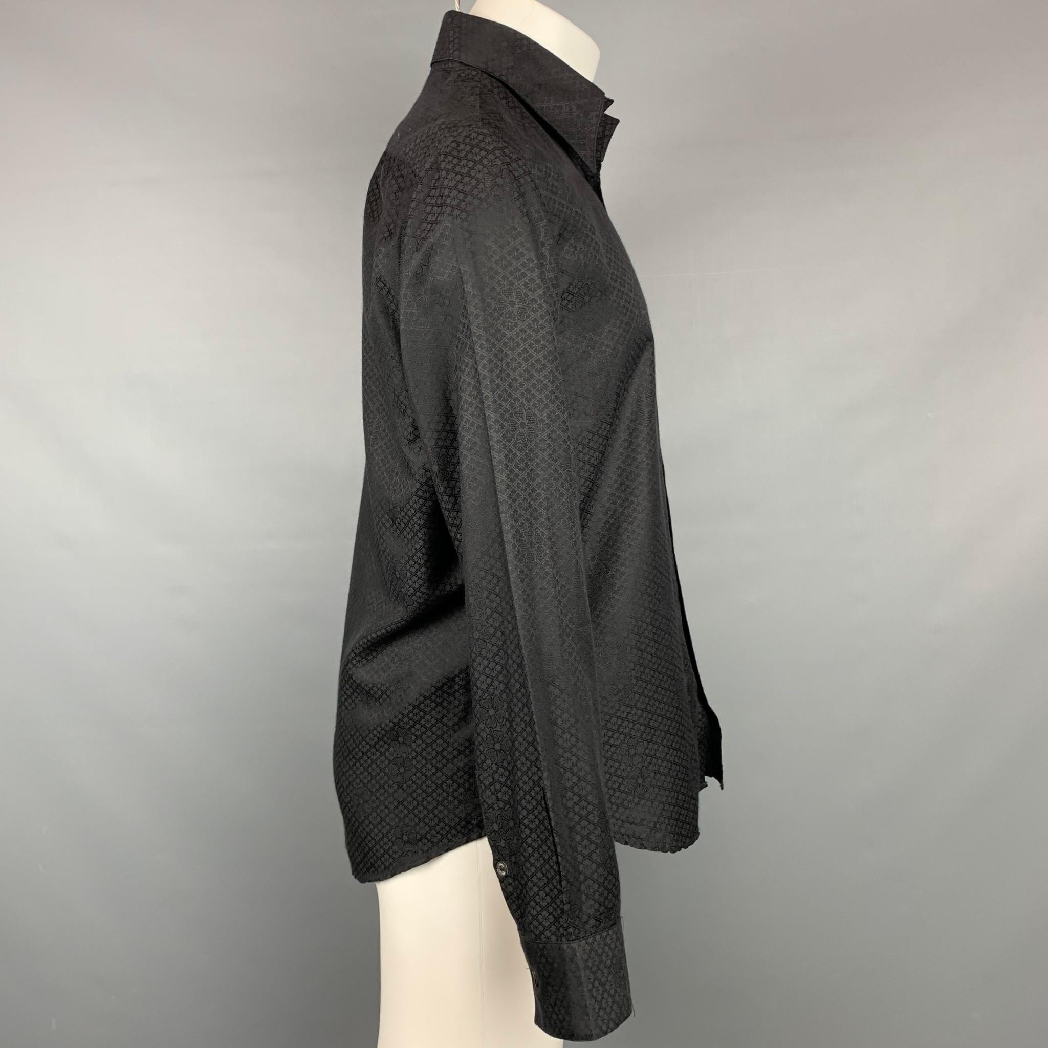 VERSUS by GIANNI VERSACE long sleeve shirt comes in a black print cotton featuring a classic style, spread collar, and a buttoned closure. Made in Italy.

Very Good Pre-Owned Condition. Minor marks at under arm.
Marked: