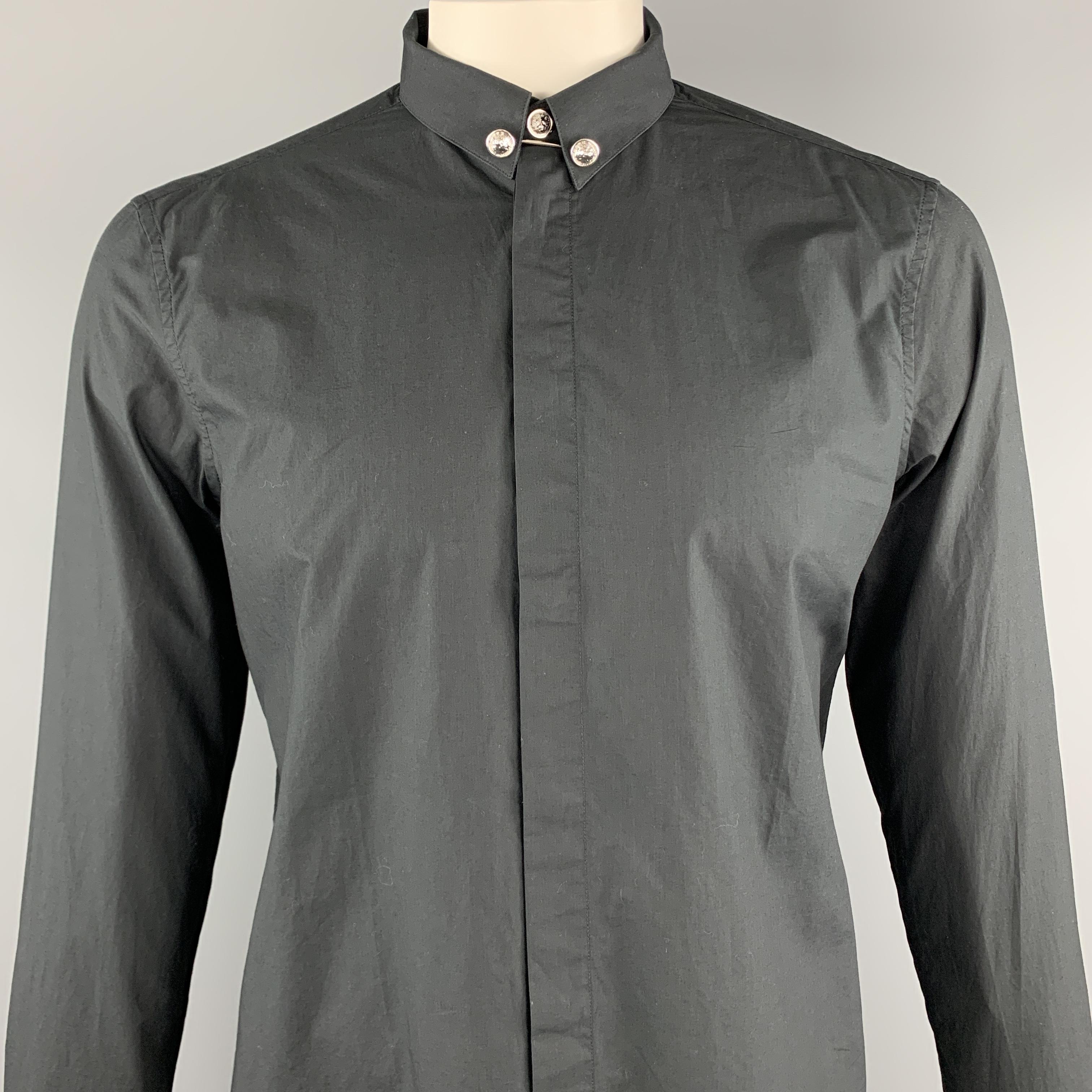 VERSUS by GIANNI VERSACE long sleeve shirt comes in a black cotton featuring a button up style, lion head details, and a hidden buttoned closure. Made in Bulgaria.

New With Tags.
Marked: 50

Measurements:

Shoulder: 16 in. 
Chest: 44 in. 
Sleeve: