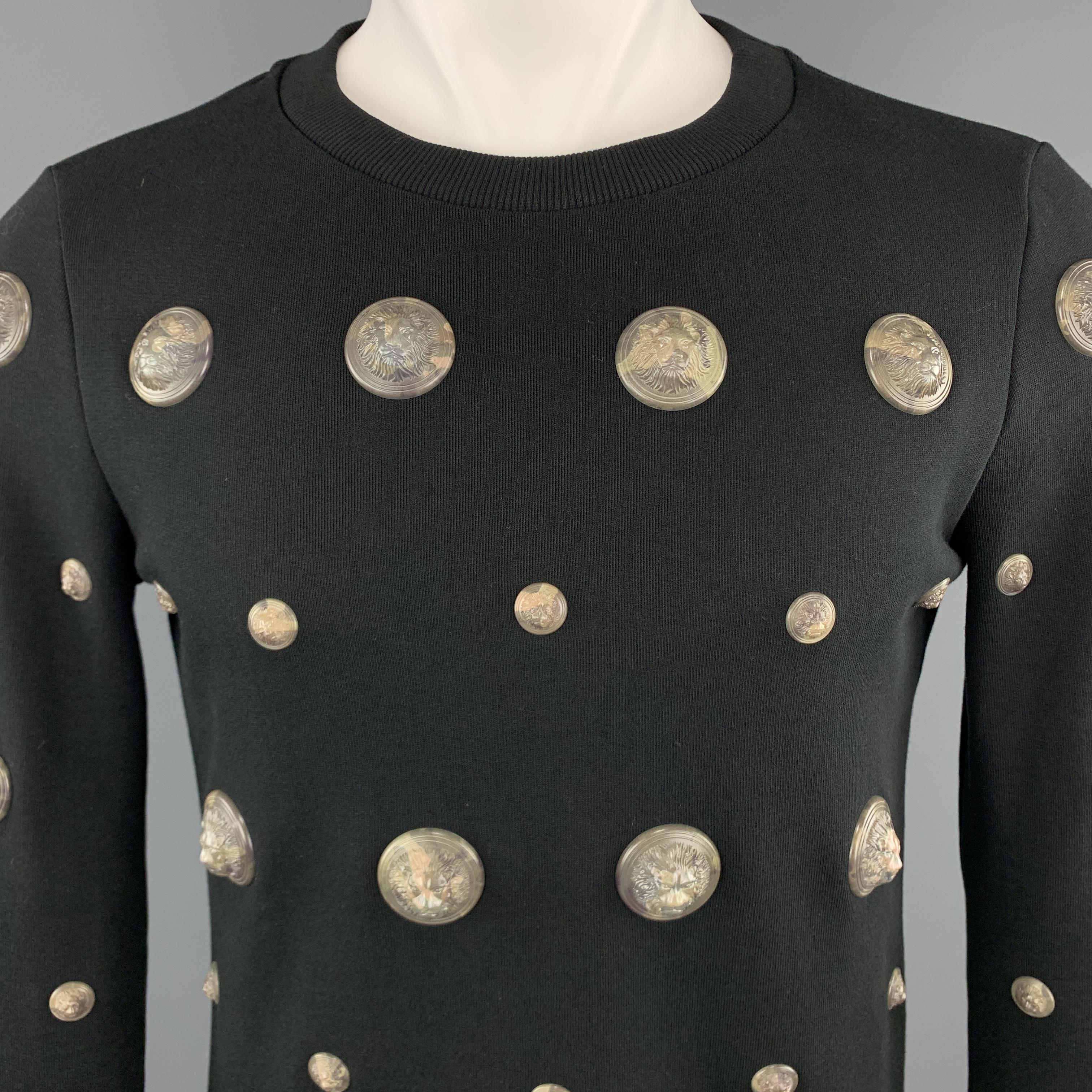 VERSUS by GIANNI VERSACE pullover sweatshirt comes in black jersey with a crewneck and oversized camouflage marble textured 3D lion head studs. Made in Italy.

Excellent Pre-Owned Condition.
Marked: (no size)

Measurements:

Shoulder: 16 in.
Chest: