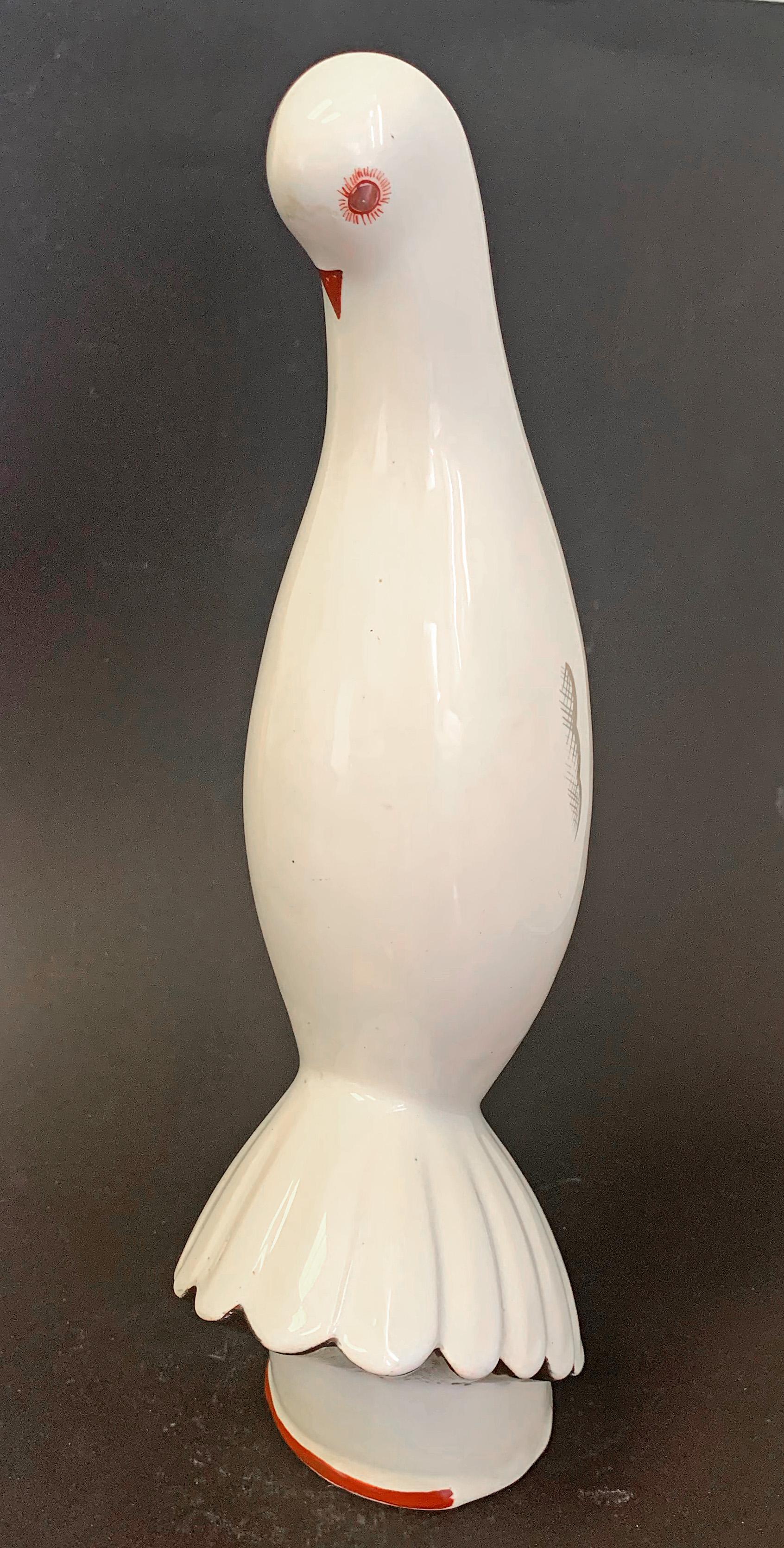 Almost Brancusi-esque in its sleek economy of form, this very rare porcelain sculpture was created by the Primavera workshop, and depicts a lean, vertical pigeon with a discreet spray of tail features, its beak tucked into its breast. The form is