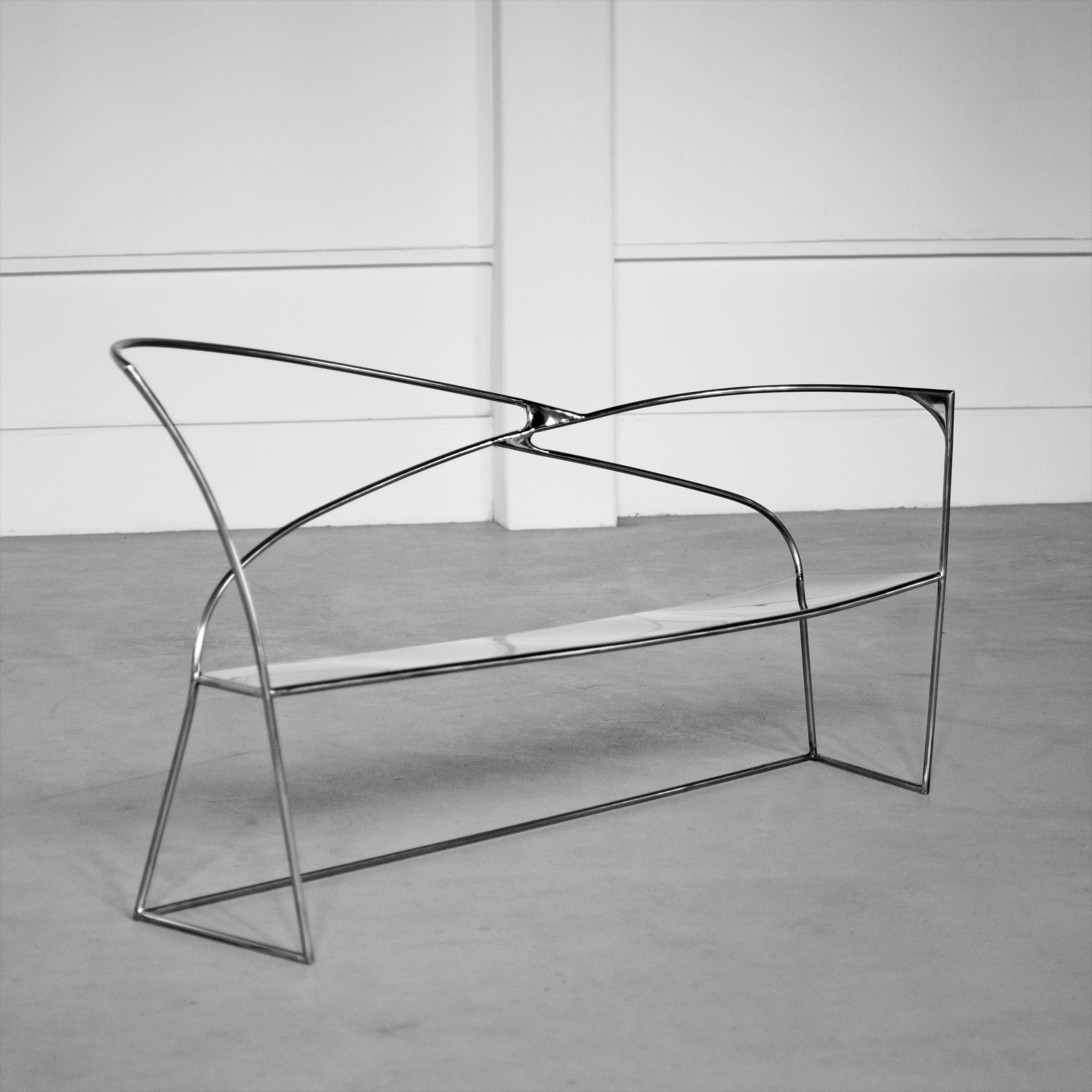 Vertigo Bench by Pol Quadens 
Unique Piece.
Dimensions: D 65 x W 220 x H 80 cm.
Materials: Polished stainless steel.

Pol Quadens was born in Brussels. His father was active in the fields of composites the metal industry, and the world of materials,