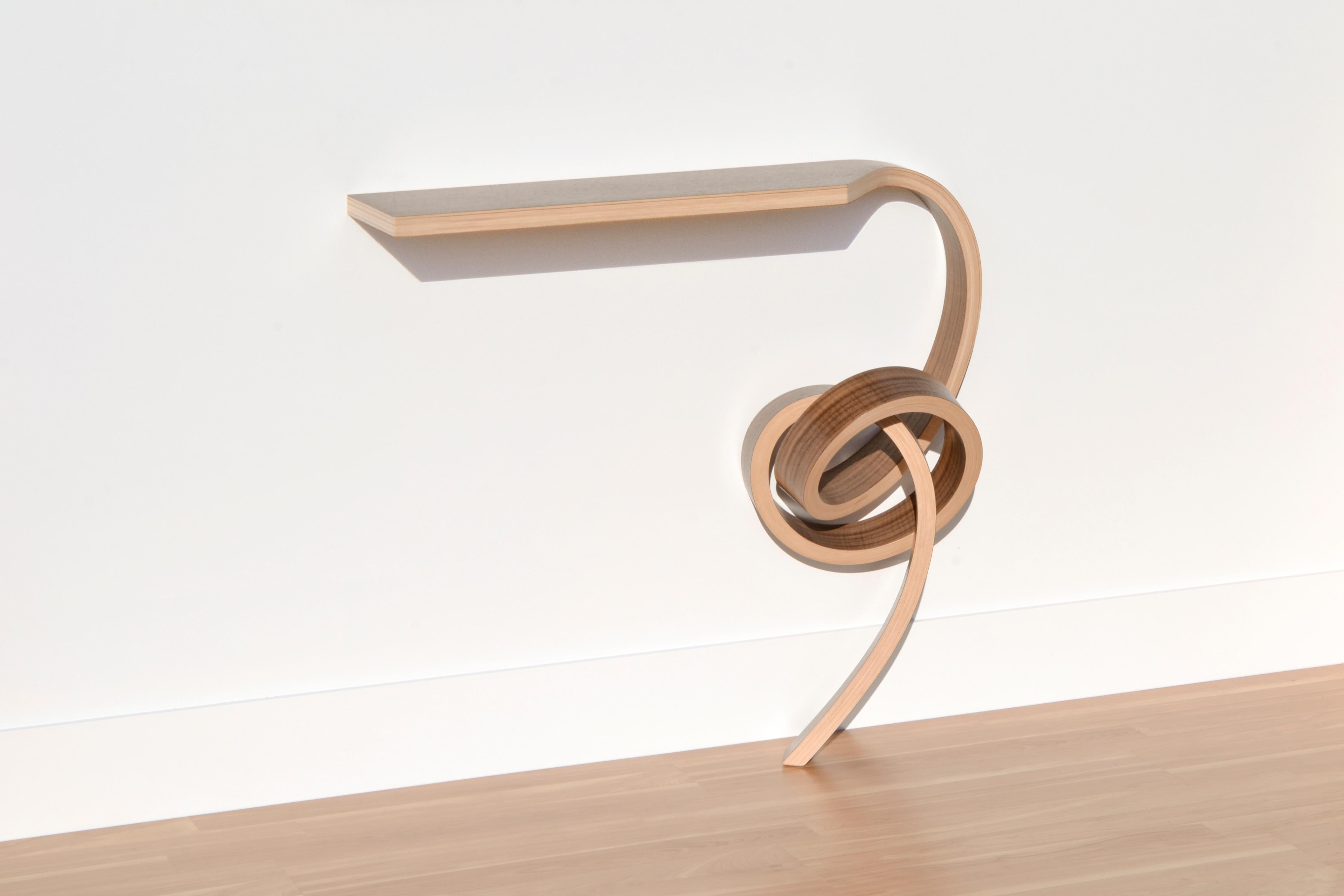 This console table has been bent into the knotted form. This table is made with laminated bent plywood and Walnut veneer.

It is wall mounted. Mounting hardware and instructions are included.

Overall size: 33
