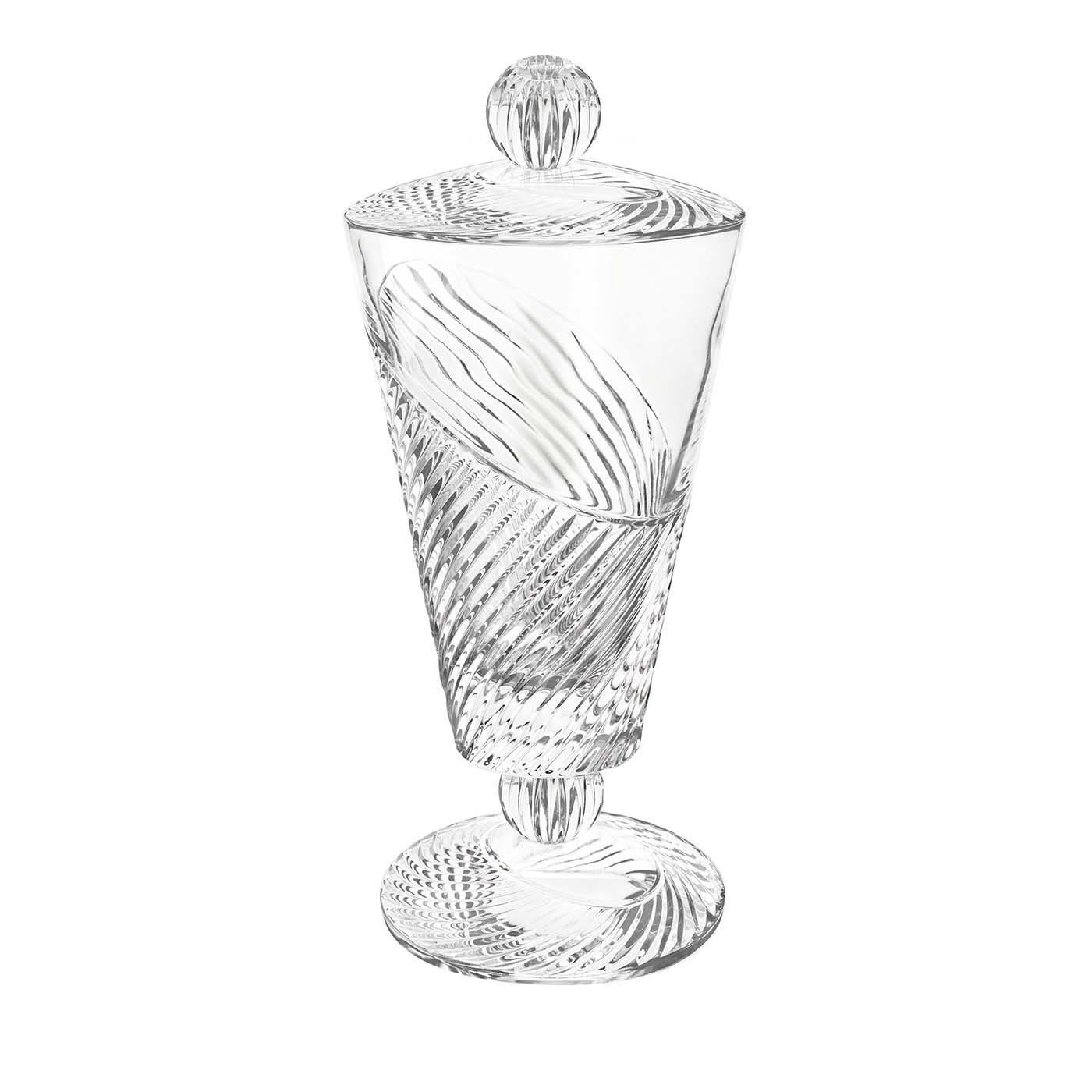 Part of the Vertigo collection, this vase with lid was crafted of transparent glass and features a footed shape and a conical bowl. The smooth surface of the piece is adorned with an etched decoration that boasts a dynamic tension thanks to a series