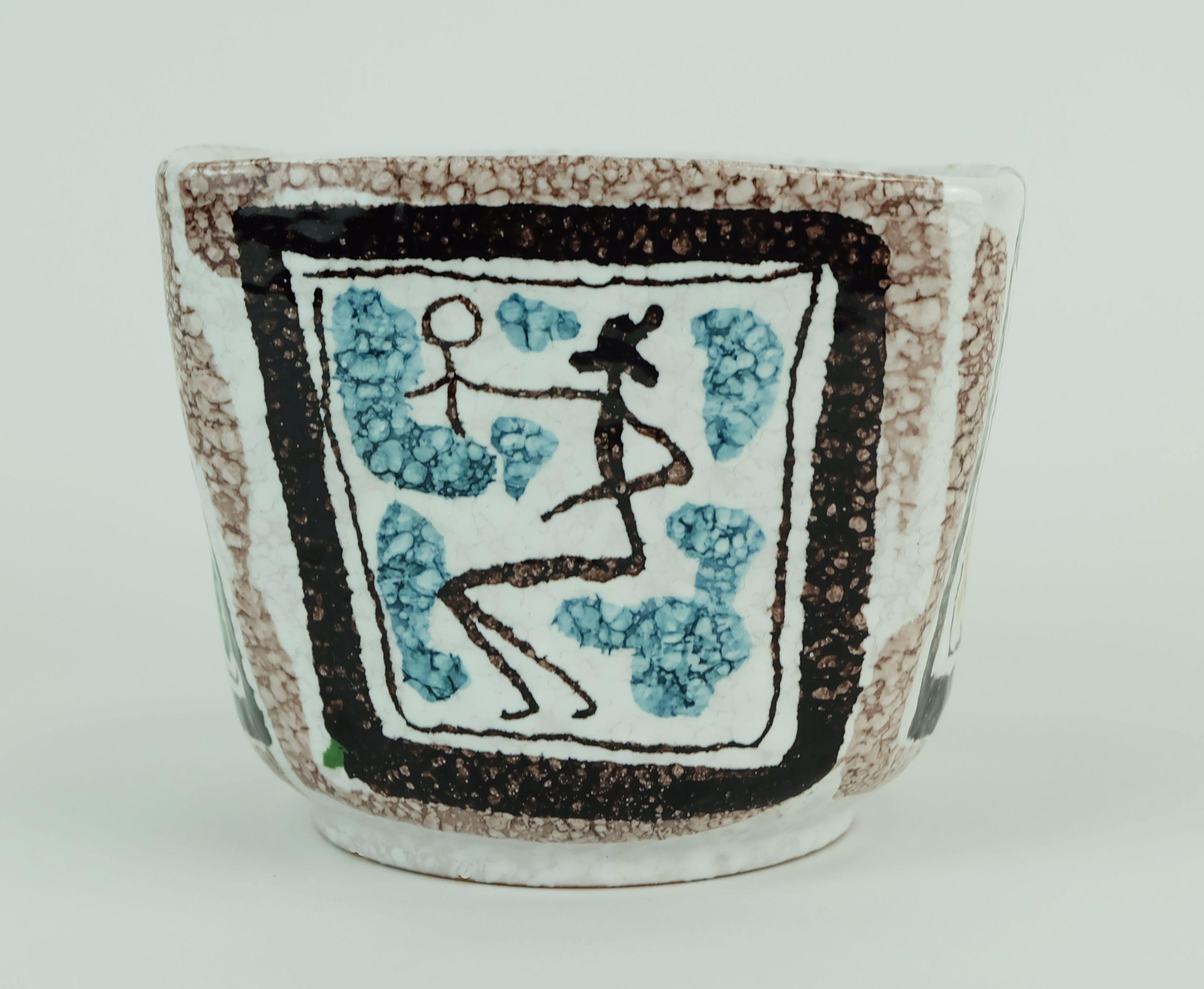 A very decorative small cachepot from the 1950s to 1960s. Square shape on a round base. Figurative depictions on all four sides. Marked 625/208 Italy on the base. Designer unknown, most probably Alvino Bagni. 

Dimensions in cm: 
Height 10 cm, width