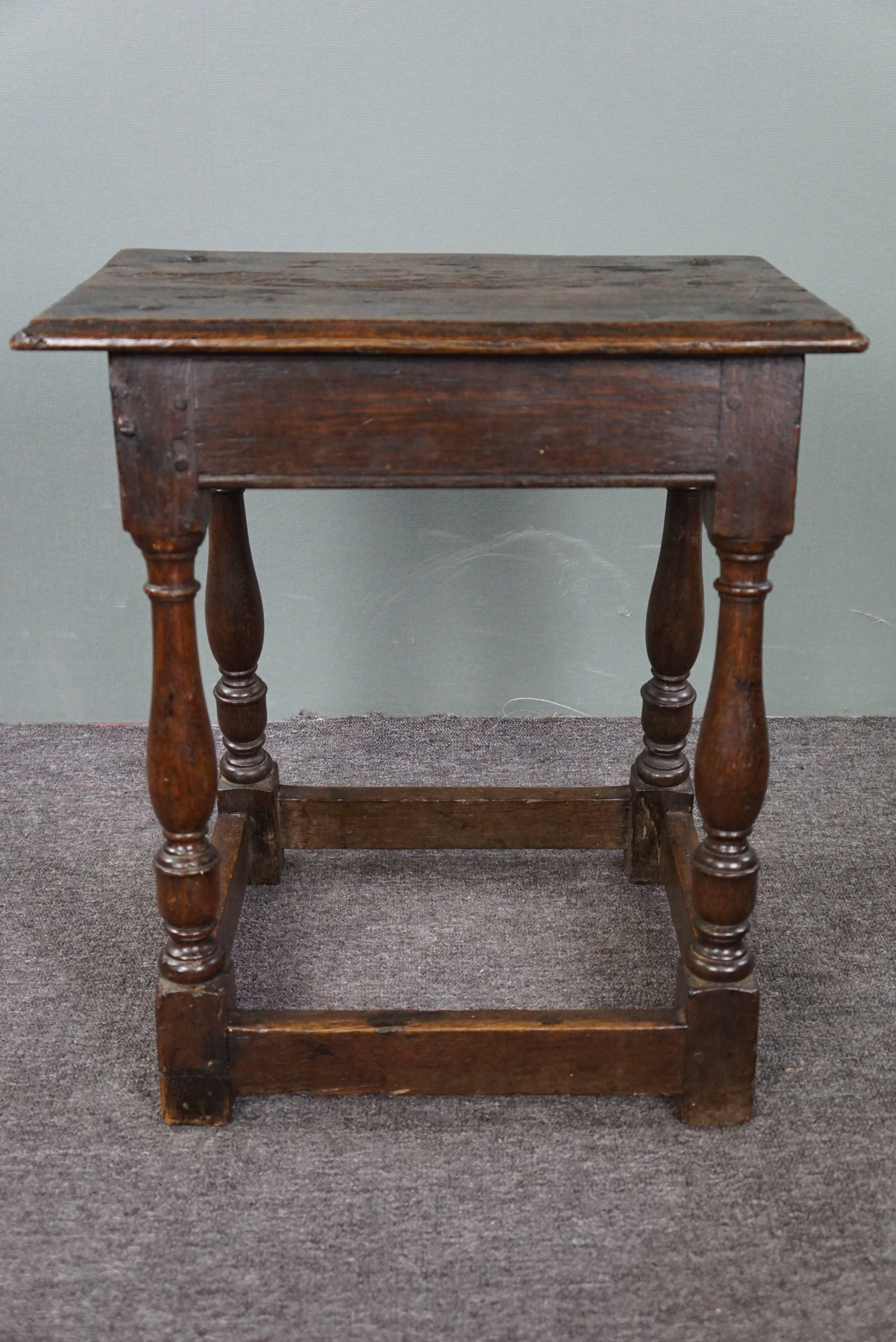 Offered is this exquisite and notably original English 16th-century oak joint stool. This very beautiful and notably original 16th-century joint stool is in good and fully functional condition. From the wood to the hand-forged nails, this is a true
