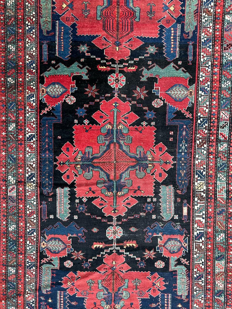 Introducing a Gorgeous Antique Hamadan Rug:
Discover an exquisite antique Hamadan rug that exudes elegance and charm. This masterpiece boasts a stunning geometrical design and features a captivating array of natural colors. Meticulously hand-knotted