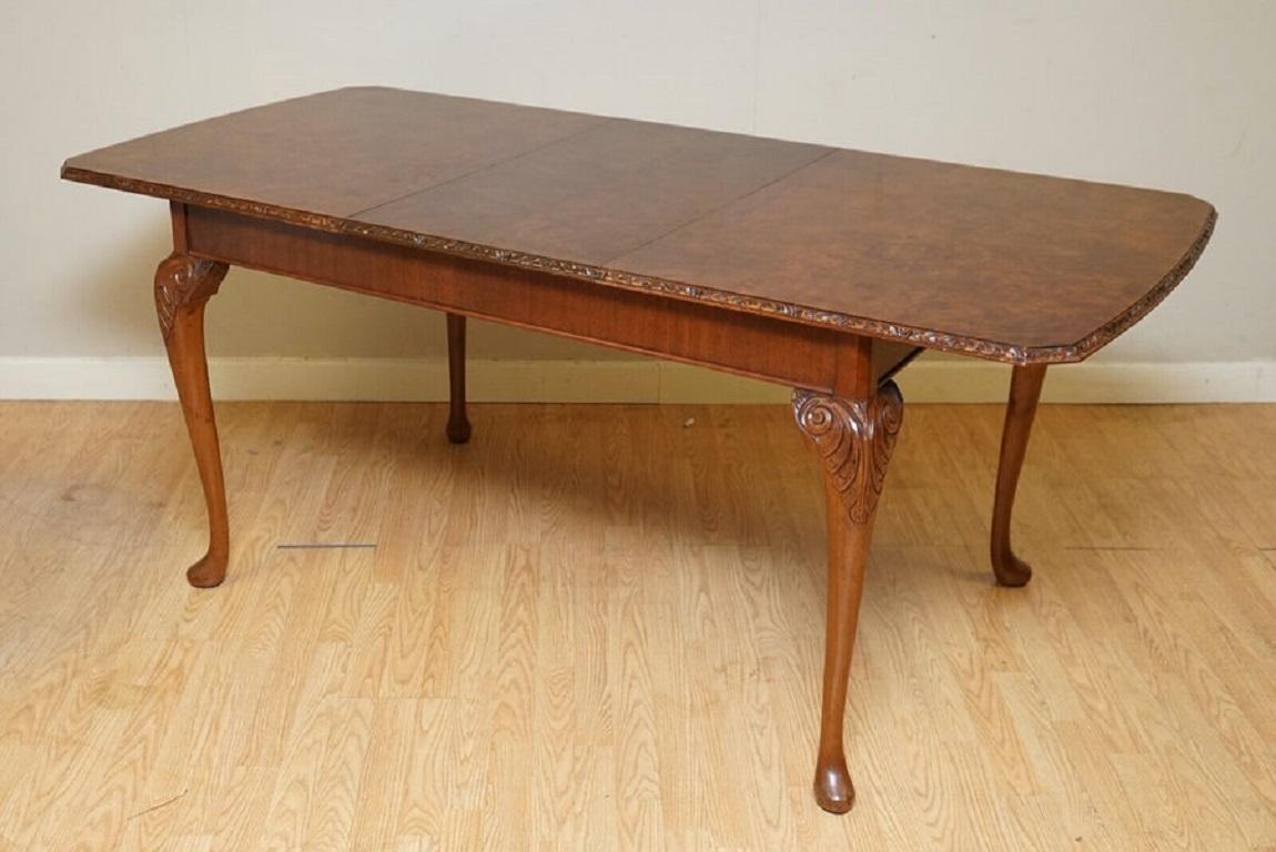 We are delighted to offer for sale this Lovely Queen Anne style burr walnut extending dining table.

This table has an absolutely stunning burr throughout the tabletop with carved edges, and it's supported by Queen Anne legs.

Lightly restored