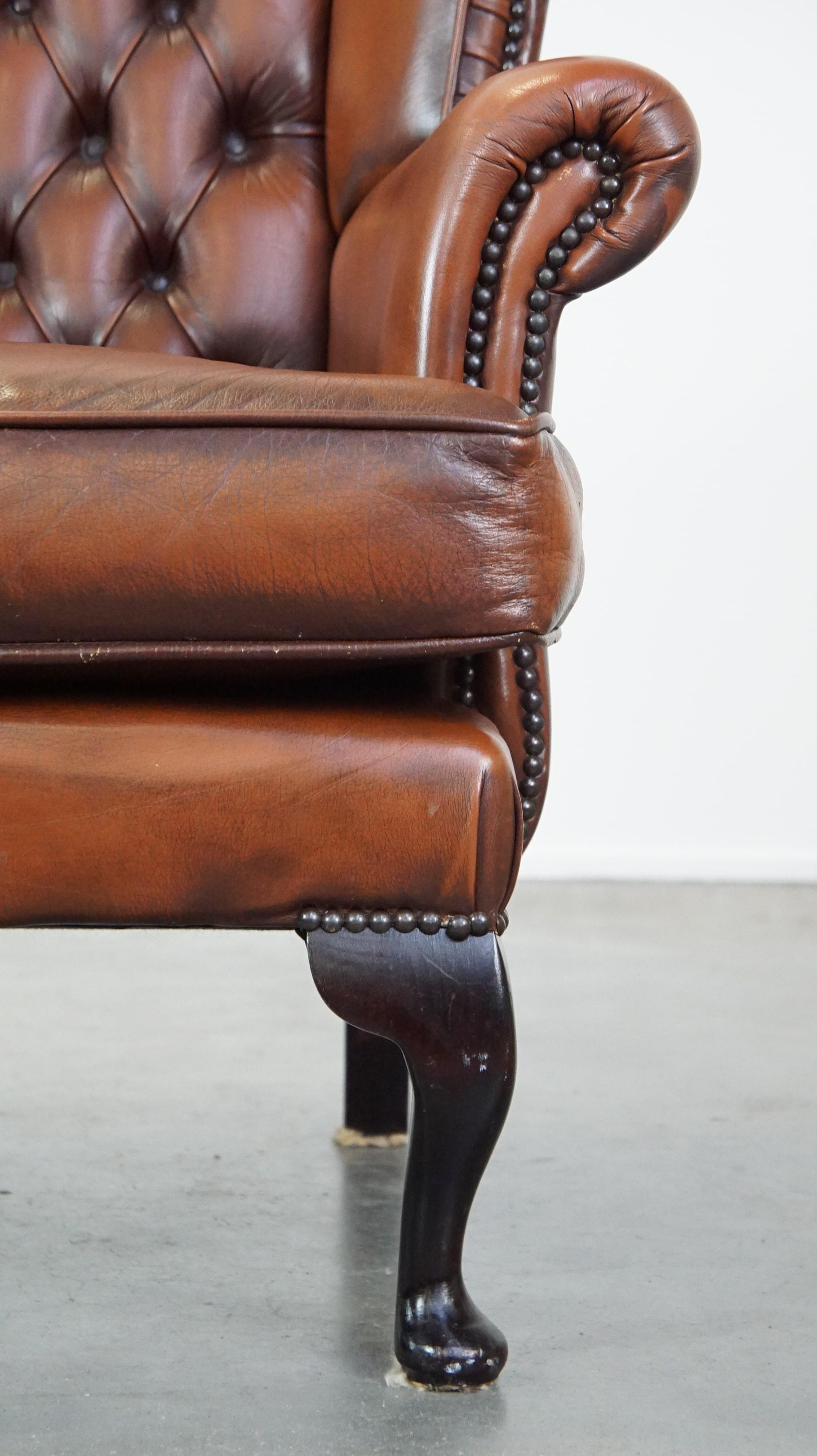 Very beautiful cowhide Chesterfield wing chair with elegant legs in brown color For Sale 4