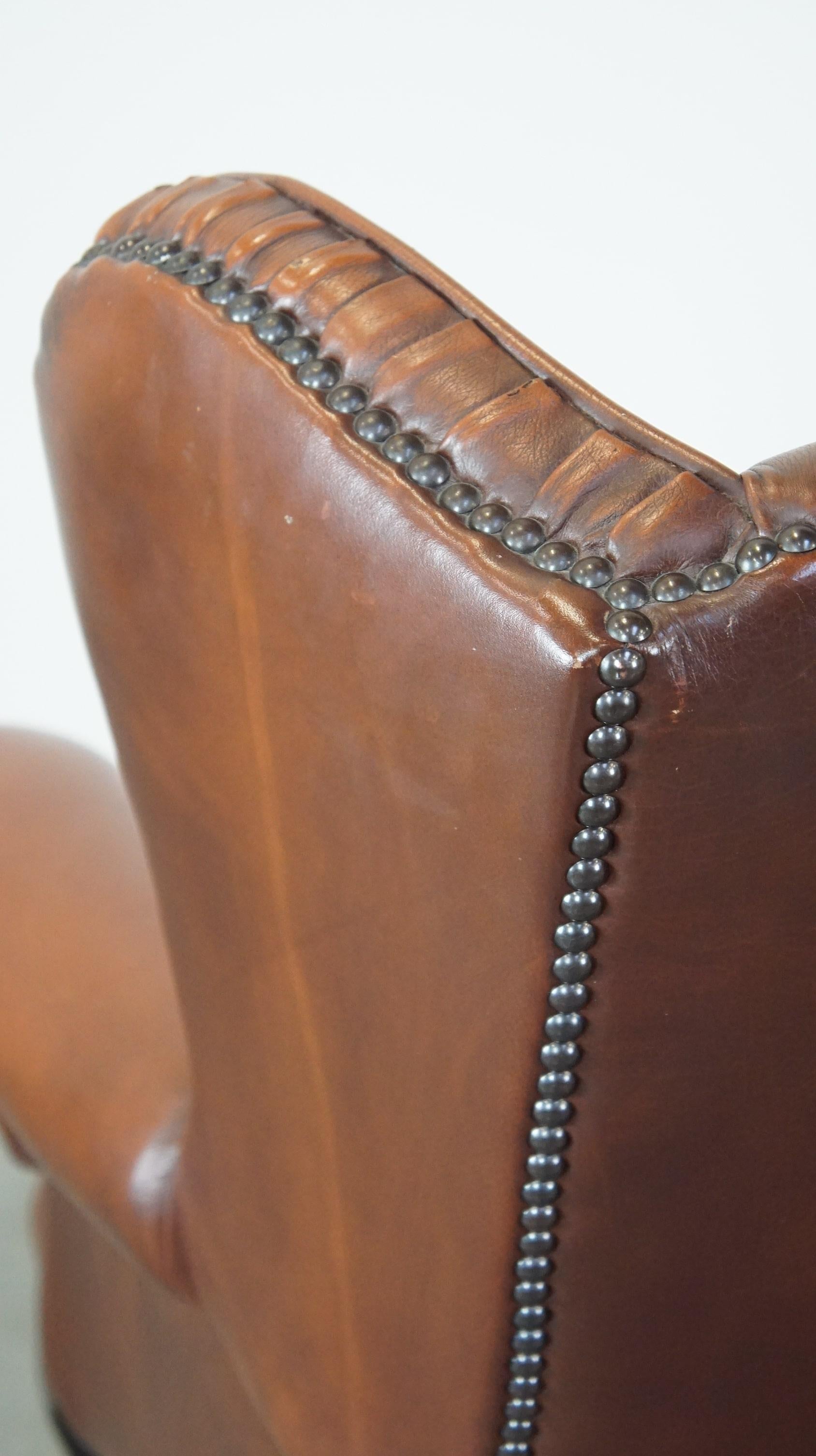 Very beautiful cowhide Chesterfield wing chair with elegant legs in brown color For Sale 5