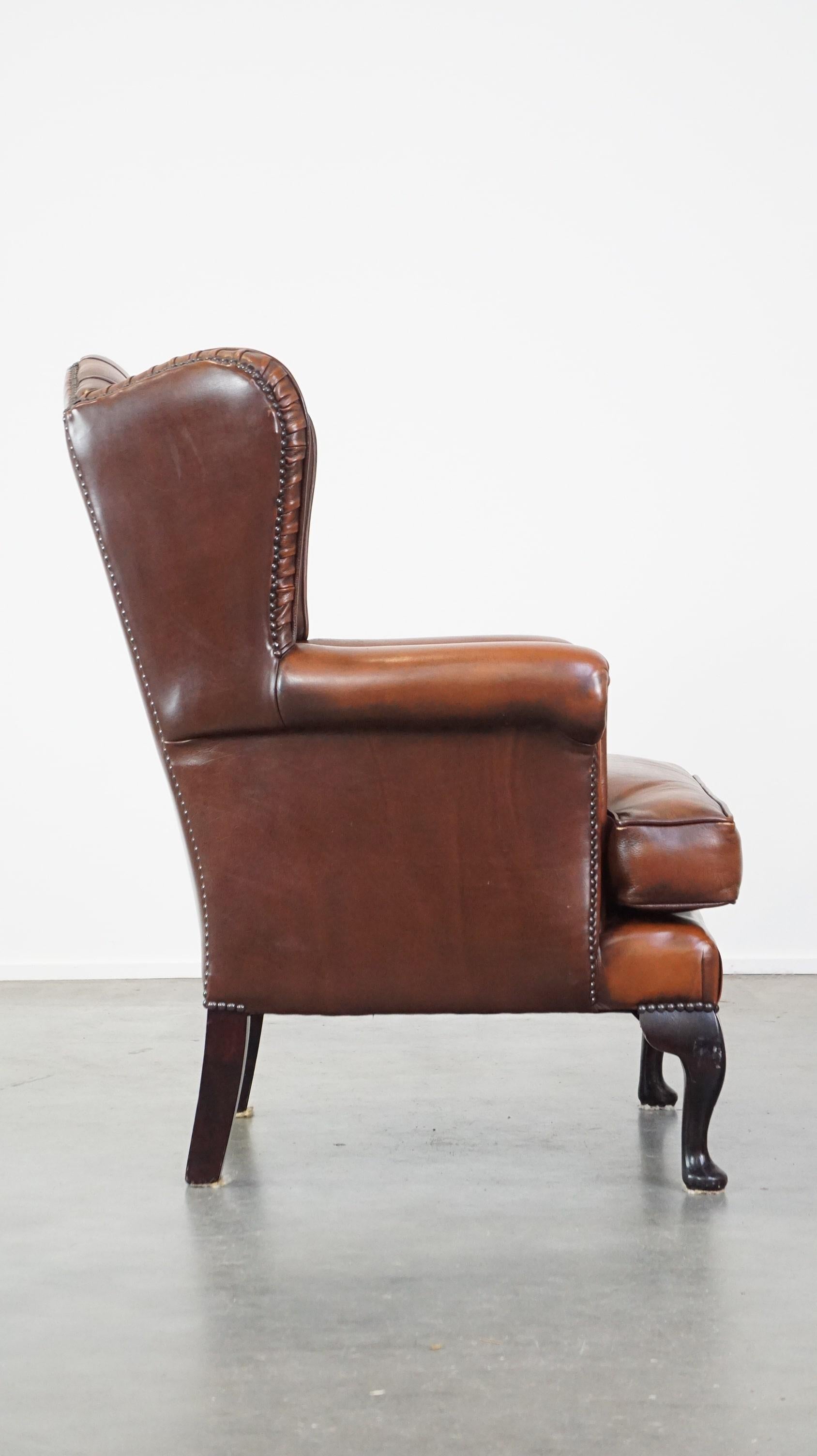 Hand-Crafted Very beautiful cowhide Chesterfield wing chair with elegant legs in brown color For Sale