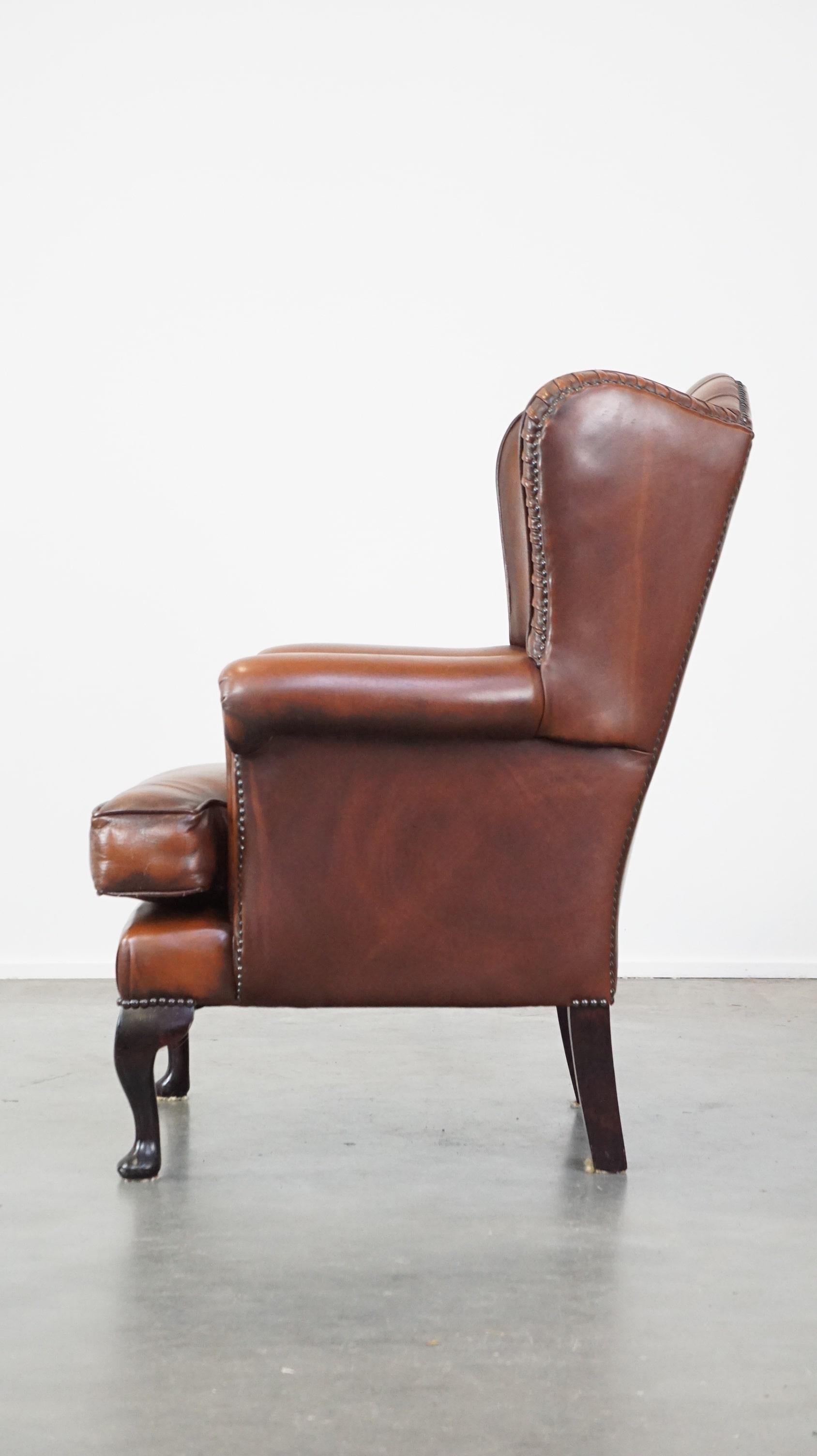 20th Century Very beautiful cowhide Chesterfield wing chair with elegant legs in brown color For Sale